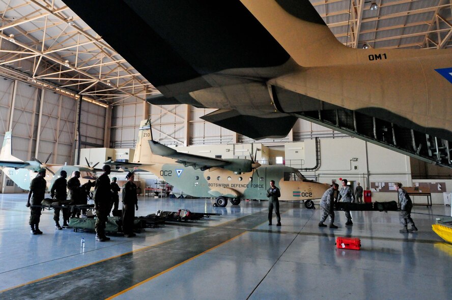 Members of the Botswana Defense Force prepare to load litters on a BDF C-130 Hercules as part of a practical exercise during MEDLITE 12 at Thebephatswa Air Base, Botswana, Aug. 11, 2012. MEDLITE is an annual exercise bringing together U.S. forces personnel with counterparts from militaries throughout Africa. The goal of the exercise is to enhance capabilities and work together by introducing the U.S. Aeromedical Evacuation system of patient movement to the BDF military personnel. (U.S. Air Force photo/Senior Airman Lausanne Morgan)