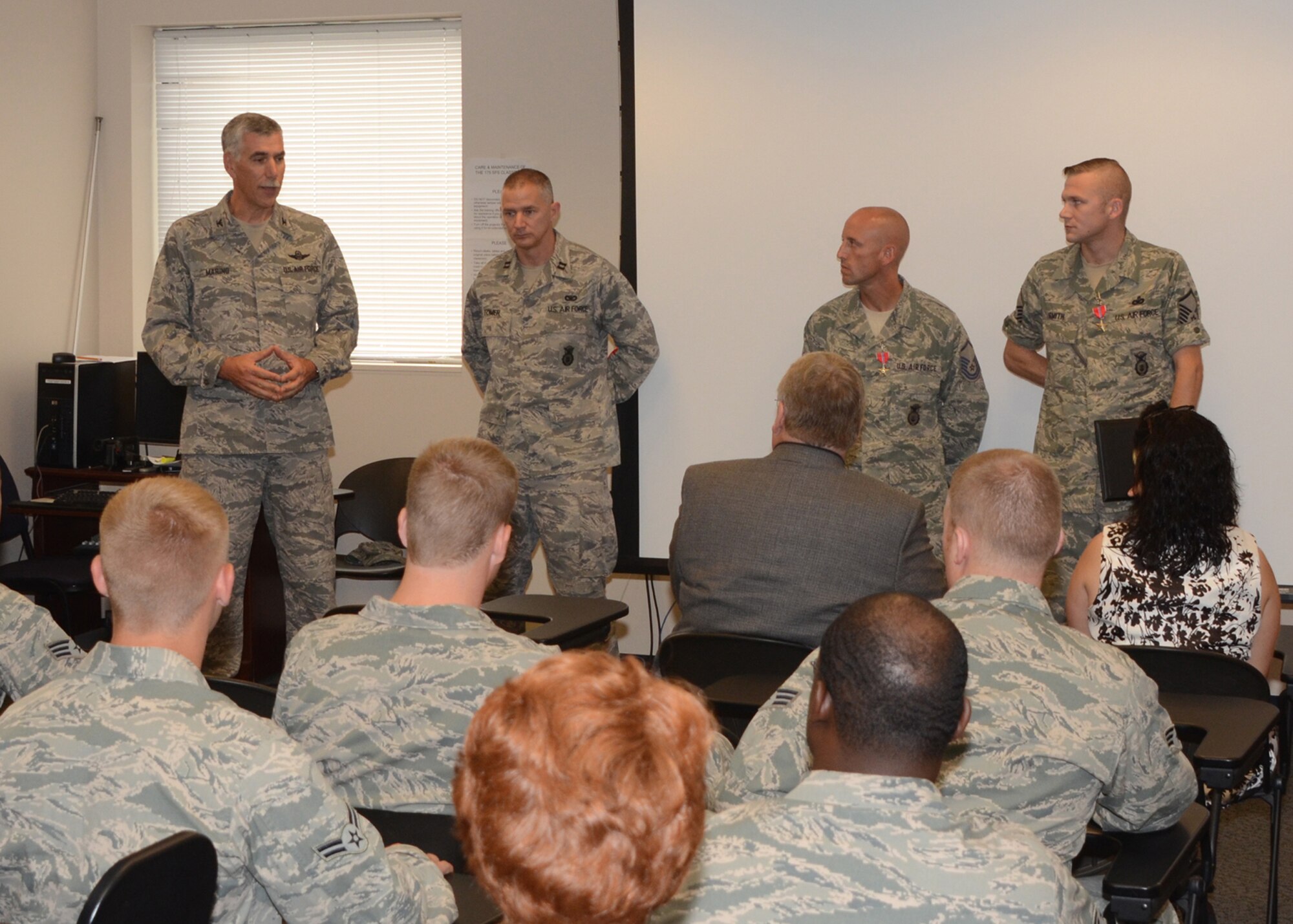 U.S. Air Force Col. Daniel Marino (left), vice commander of the 175th Wing, Maryland Air National Guard, addresses (L-R) Capt. Matthew Tower, commander of the 175th Security Forces Squadron, and Master Sgts.  John Duly and Olen D. Smith III, 175th Security Forces Squadron, after they received awards for their service while deployed.  They received their awards on August 12, 2012 at Warfield Air National Guard Base.  (National Guard photo by TSgt. Chris Schepers)