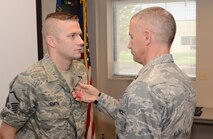 Captain Matthew Tower, commander 175th Security Forces Squadron, presents Master Sgt. Olen D. Smith III, 175th Security Forces Squadron, with the Bronze Star Medal.  Smith was presented the award on August 12, 2012 at Warfield Air National Guard Base for his duty in Bagram, Afghanistan. (National Guard photo by TSgt. Chris Schepers)