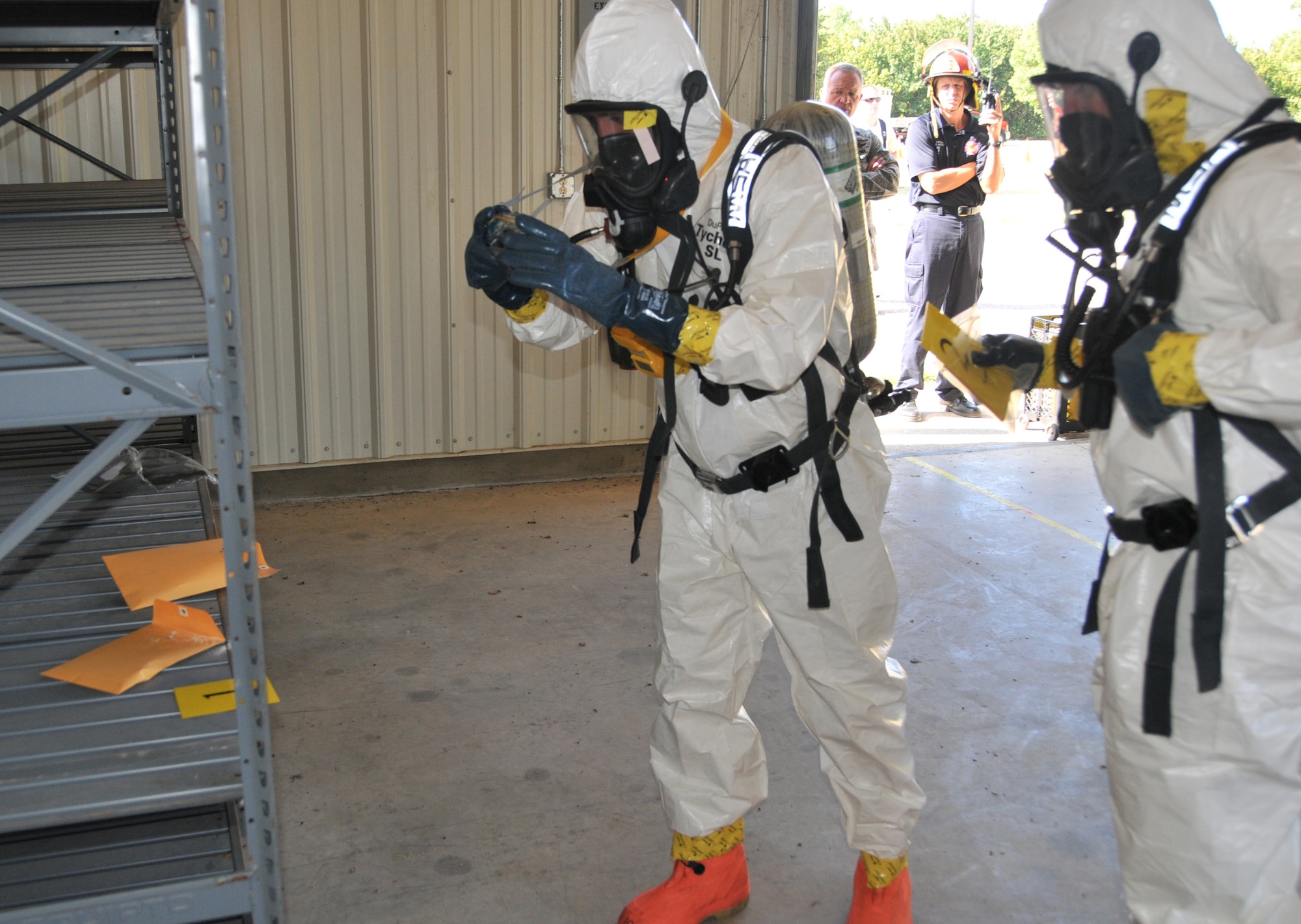 Brandon Black and Paul Johnson, members of the Sioux City Fire Department, take a photo of an envelope containing a suspicious substance, during a “White Powder” exercise, August 10, 2012. Members of the 185th worked with the Sioux City Fire Department to test their ability to report, control, test, and remove potentially deadly chemicals. (U.S. Air National Guard Photo by Tech. Sgt. Richard Murphy/ Released)