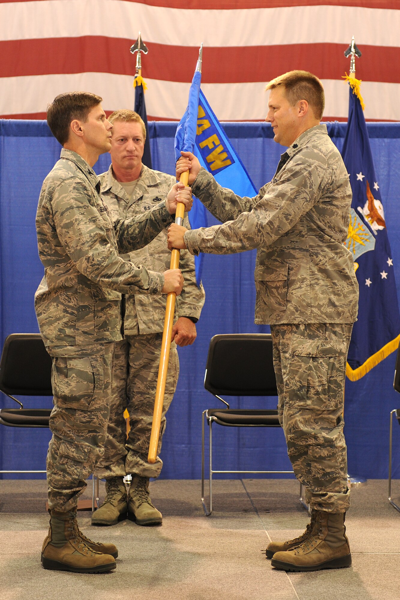 New York Air National Guard Lt. Col. Michael Smith (right) receives the 174th Fighter Wing Maintenance Group Guideon from 174th Fighter Wing Commander Col. Greg Semmel during a change of command ceremony held on August 11, 2012 at Hancock Field Air National Guard Base.  Lt. Col. Smith assumed command of the Maintenance Group from Col. John Balbierer. Lt. Col. Smith previously served as commander of the 138th Fighter Squadron stationed on Hancock Field.. (Photo by New York Air National Guard Staff Sgt. James N. Faso II/Released)
