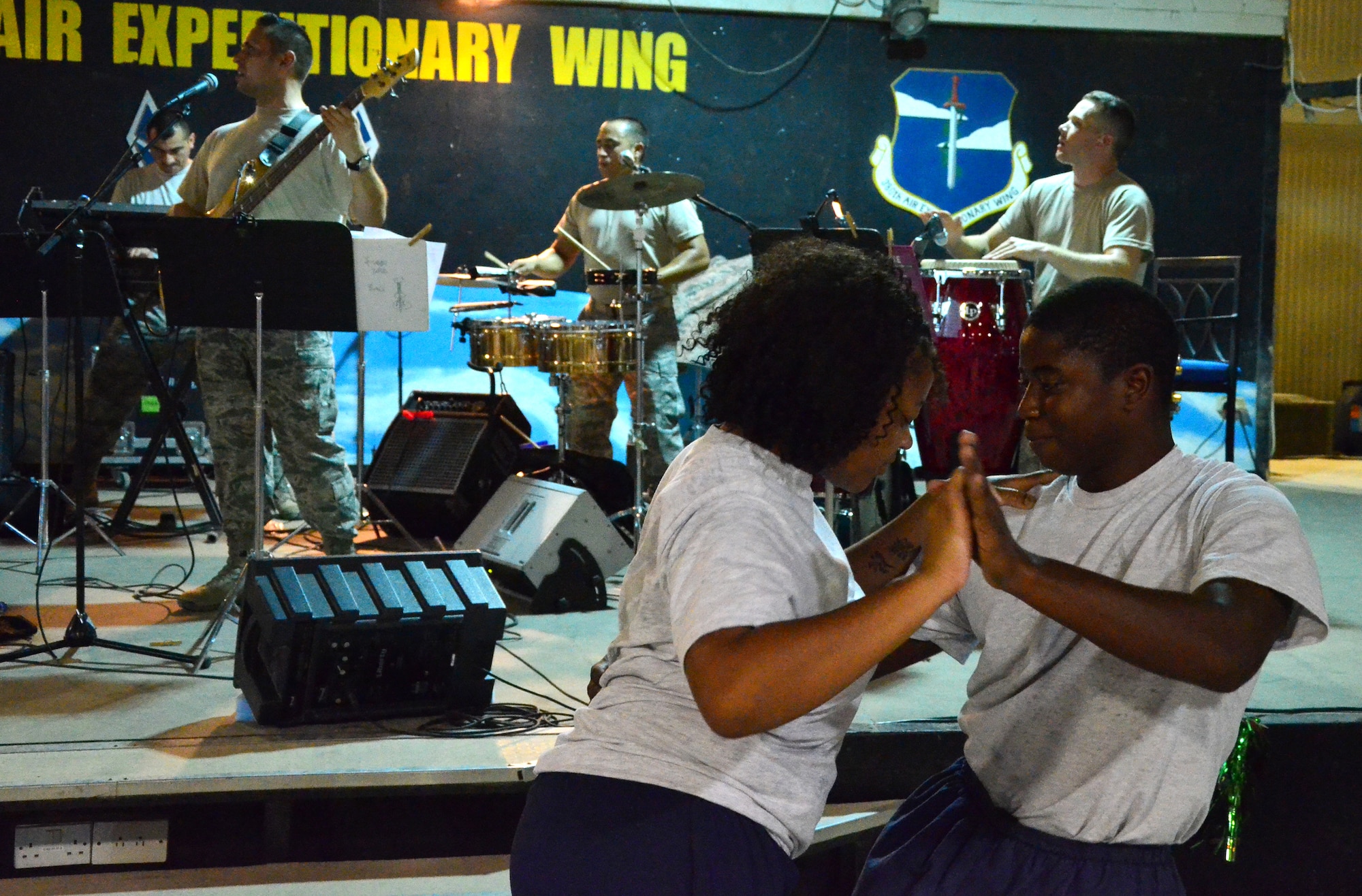 SOUTHWEST ASIA - U.S. Air Force Senior Airman Jamie Ferguson and Airman 1st Class Jasper Brooks salsa dance during a U.S. Air Forces Central band Vector performance here Aug. 8, 2012. Members of the 380th Air Expeditionary Wing's salsa dance class were included in the band's salsa concert to enhance the show and showcase the class here. (U.S. Air Force photo/Senior Airman Jared Elliott)