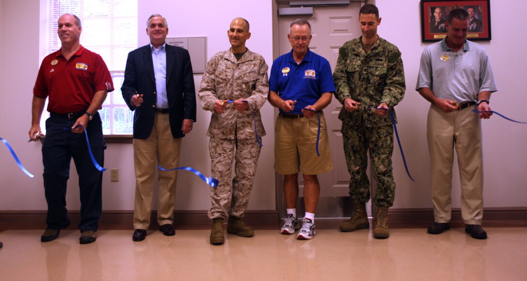 The ceremonial ribbon for the new McIntyre-Parks Recreational Shooting Complex aboard Marine Corps Base Camp Lejeune is cut by different Marine Corps Community Services and Semper Fit representatives, along with Brig. Gen. Thomas A. Gorry (center), commanding general of Marine Corps Installations East –MCB Camp Lejeune, Aug. 10. The new range with state-of-the-art technologies is replacing the older skeet shooting range on base.