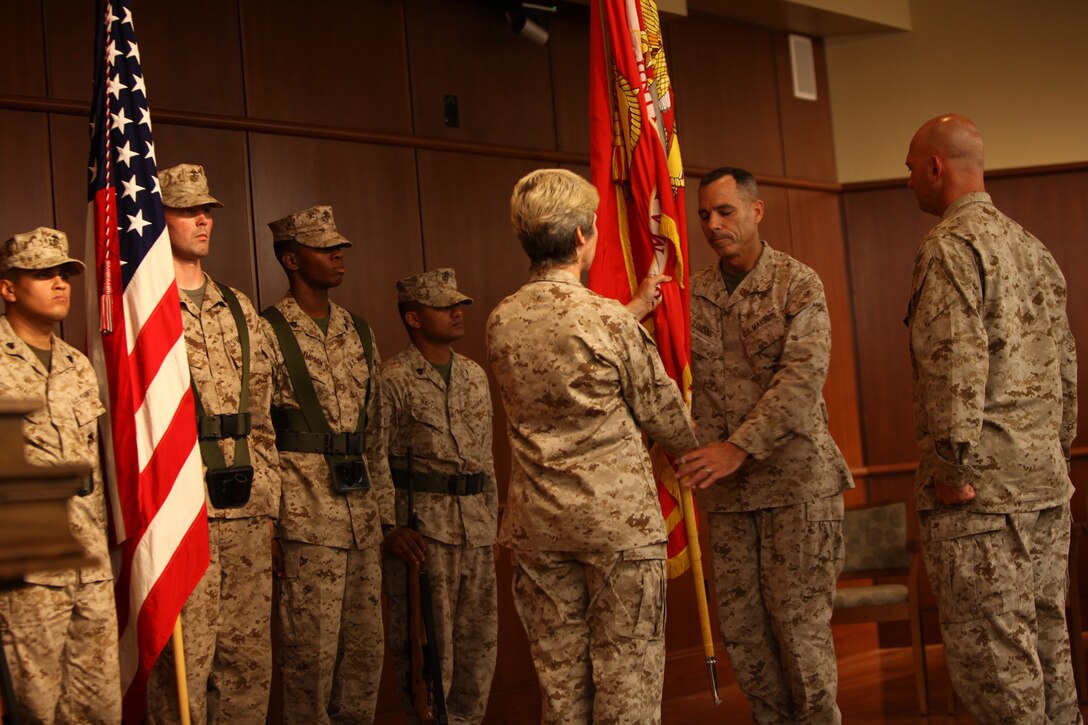 Maj. Gen. Tracy L. Garrett, the commanding general of Force Headquarters Group, passes the Marine Corps colors to Brig. Gen. Paul. K. Lebidine, the former chief-of-staff for force command element, Javelin Thrust, here, Aug. 6. The passing of the colors is symbolic of the change of command. During the ceremony, FHG was formally recognized as a new major subordinate command of Marine Forces Reserve. 