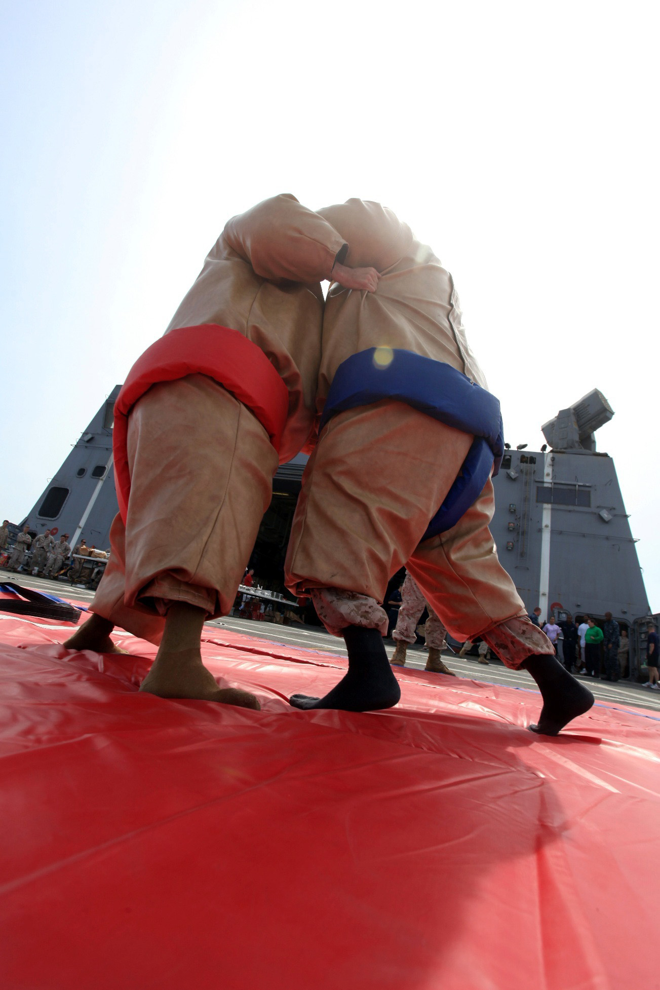 Marines with 24th Marines Expeditionary Unit grapple during a sumo-wrestling match on the flight deck of the USS New York during a steel beach picnic to commemorate the halfway point of their 8-month deployment, July 29, 2012. The 24th MEU is deployed with the Iwo Jima Amphibious Ready Group as a U.S. Central Command theater reserve force providing support for maritime security operations and theater security cooperation efforts in the U.S. 5th Fleet area of responsibility.