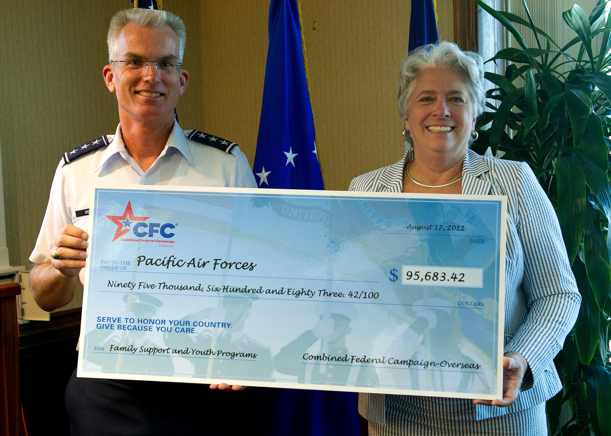 Lt. Gen. Paul J. Selva, Pacific Air Forces vice commander, accepts a check from Combined Federal Campaign overseas representative Mrs. Renee Acosta, Aug. 13, 2012, at Headquarters PACAF, Joint Base Pearl Harbor-Hickam, Hawaii. The check for $95,683.42 was to help support Family Support and Youth Programs throughout PACAF.  (U.S. Air Force photo/Tech. Sgt. Jerome S. Tayborn)
