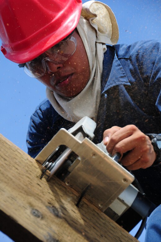 ANDERSEN AIR FORCE BASE, Guam— Senior Airman Paul Valdez, 554th REDHORSE Squadron structures, uses a circular saw to cut building material during structural framing training here July 30.  Members of the 554th are sometimes required to build 3200 sq ft structures while deployed made of wooden building materials. (U.S. Air Force photo by Senior Airman Benjamin Wiseman/Released)