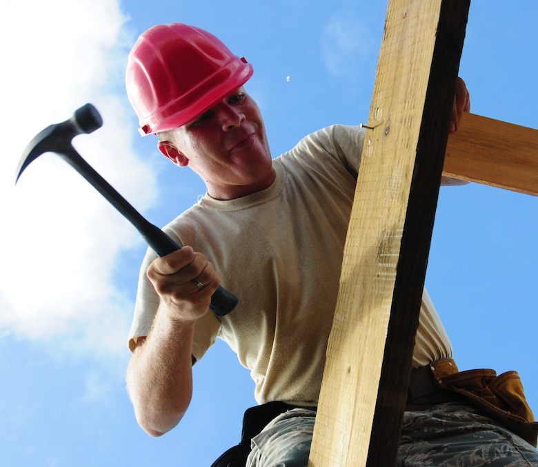 ANDERSEN AIR FORCE BASE, Guam—Airman 1st Class Matthew Hall, 554th REDHORSE Squadron structures, hammers a nail during structural framing training here July 30. When deployed, members of the 554th RHS are required to build large structures constructed out of wooden materials. Training that Airmen receive will allow them to know the basics before being required to build down range.  (U.S. Air Force photo by Senior Airman Benjamin Wiseman/Released)