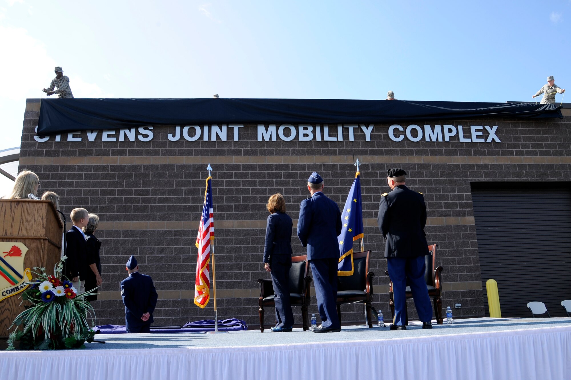 Icemen unveil the Joint Mobility Complex as the Stevens Joint Mobility Complex during a dedication ceremony Aug. 9, 2012, Eielson AFB, Alaska.  The facility is capable of processing more than 1,000 deploying personnel per day.  (U.S. Air Force photo/Staff Sgt. Jim Araos)