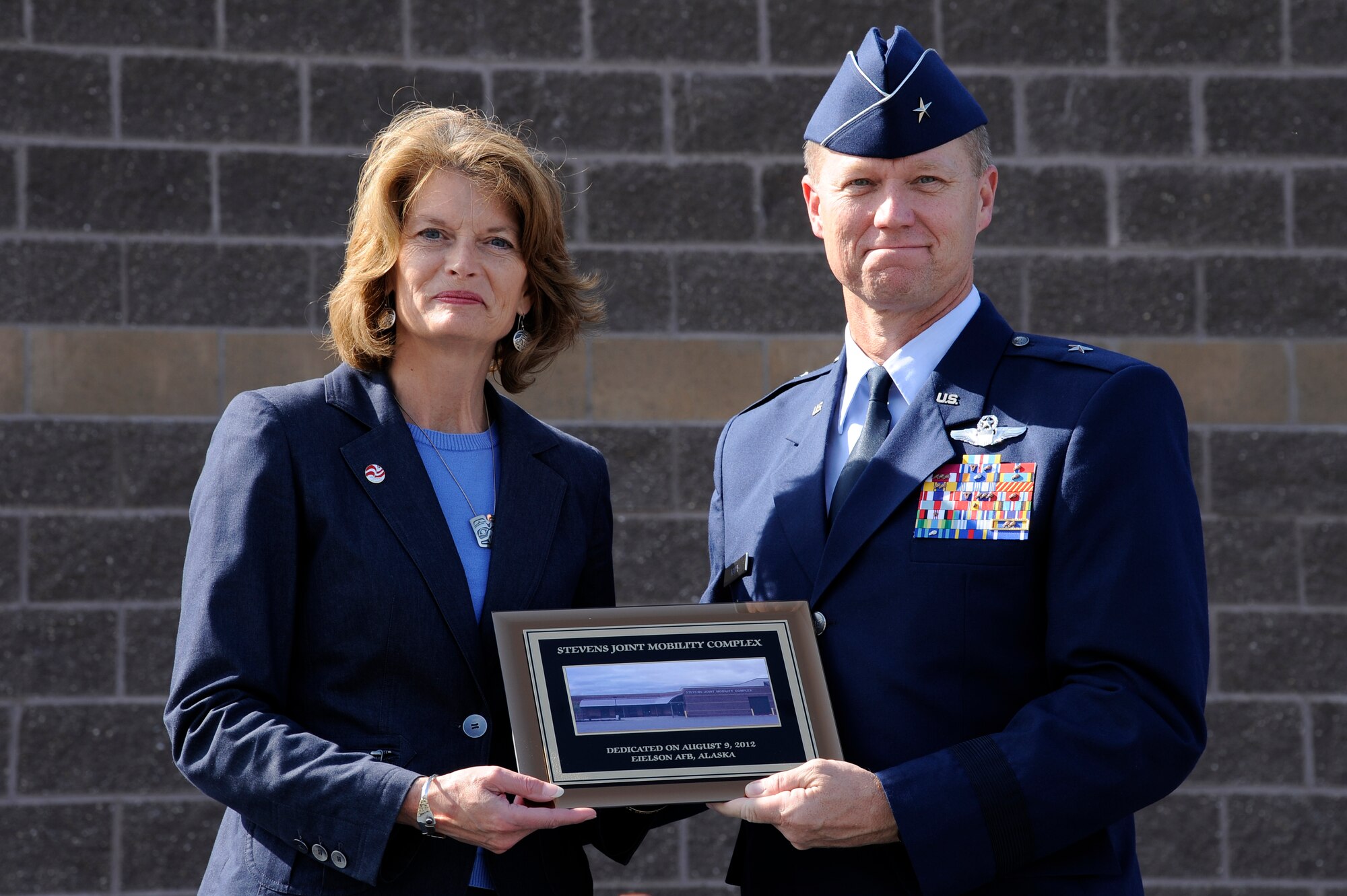 Lisa Murkowski, Alaskan senator, and U.S. Air Force Brig. Gen. Mark Kelly, 354th Fighter Wing commander, commemorate the Stevens Joint Mobility Complex dedication ceremony Aug. 9, 2012, Eielson Air Force Base, Alaska. The facility was renamed in honor the late Senator Ted Stevens. (U.S. Air Force photo/Staff Sgt. Jim Araos)