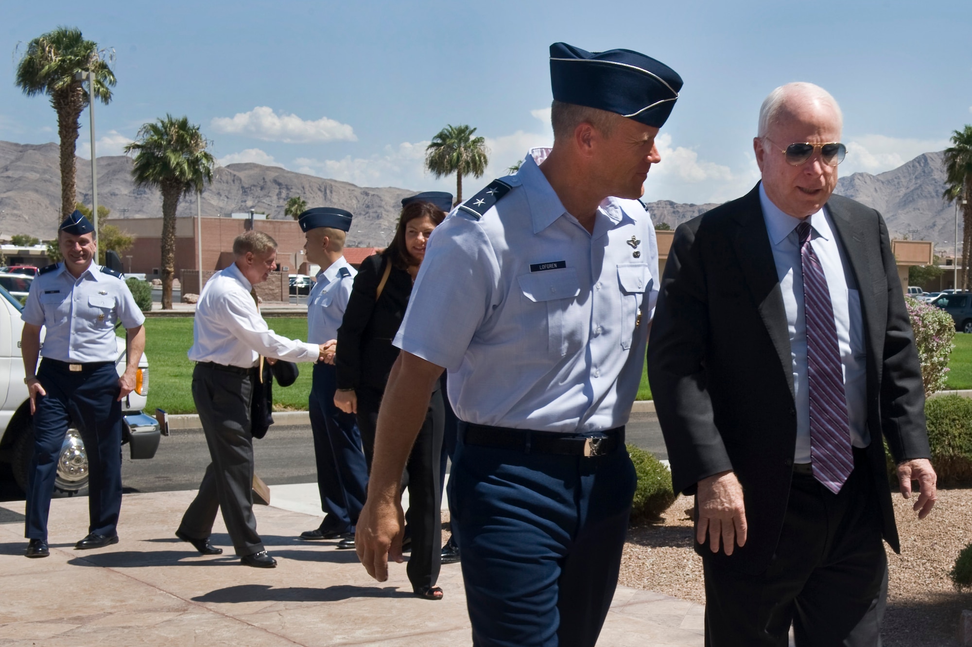 U.S. Air Force Warfare Center commander, Maj. Gen. Jeffrey Lofgren, speaks with Senator John McCain, R-Ariz., as they enter the USAFWC  Aug. 13, 2012, on Nellis Air Force Base, Nev.  McCain, accompanied by Senators Lindsey
Graham, R-S.C., and Kelly Ayotte, R-N.H., visited Nellis to receive a  base tour and mission briefing. This visit took place prior to the senators
attending a Las Vegas town hall meeting the same day. (U.S. Air Force photo by Airman 1st Class Daniel Hughes)

 
 
