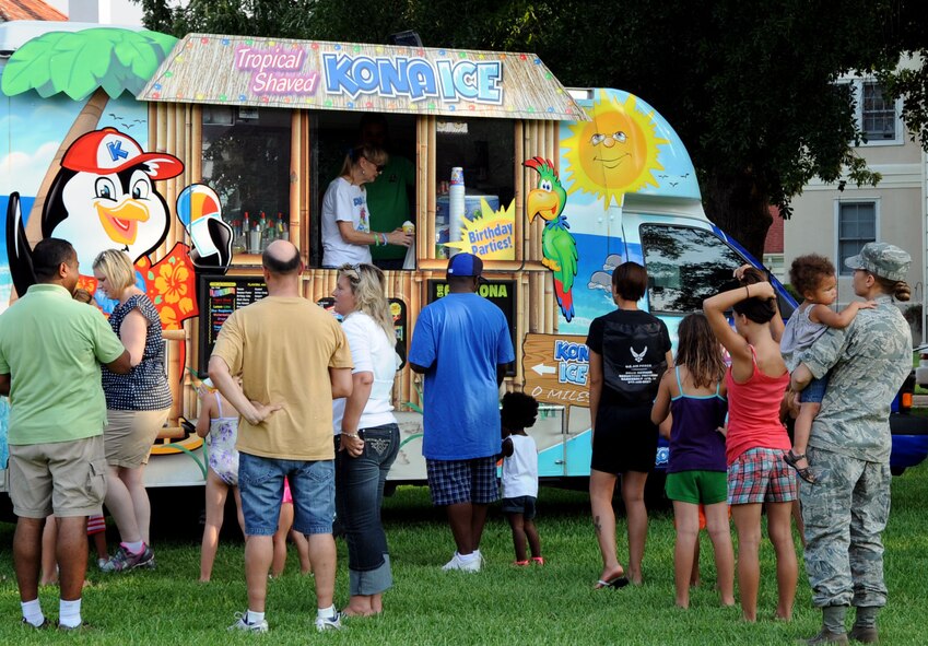 Members of Team Barksdale line up at a sno-cone truck during the annual Nation Night Out on Barksdale Air Force Base, La., Aug 7. National Night Out is a world-wide event hosted on the first Tuesday in August to raise awareness and take a stand against crime. (U.S. Air Force photo/ Senior Airman La'Shanette V. Garrett)(RELEASED)