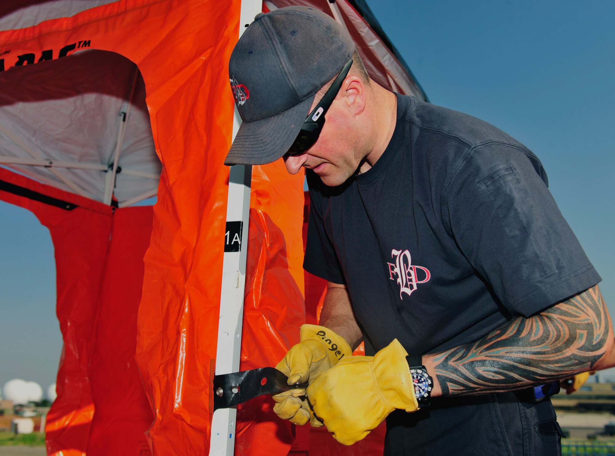 BUCKLEY AIR FORCE BASE, Colo. – Buckley Fire Department firefighter Eric Pingel, 460th Civil Engineer Squadron, assembles de-contamination equipment for used for hazardous material training Aug. 10, 2012. Buckley firefighters exercise hazardous de-contamination procedures several times a year. (U.S. Air Force photo by Airman 1st Class Darryl Bolden Jr)