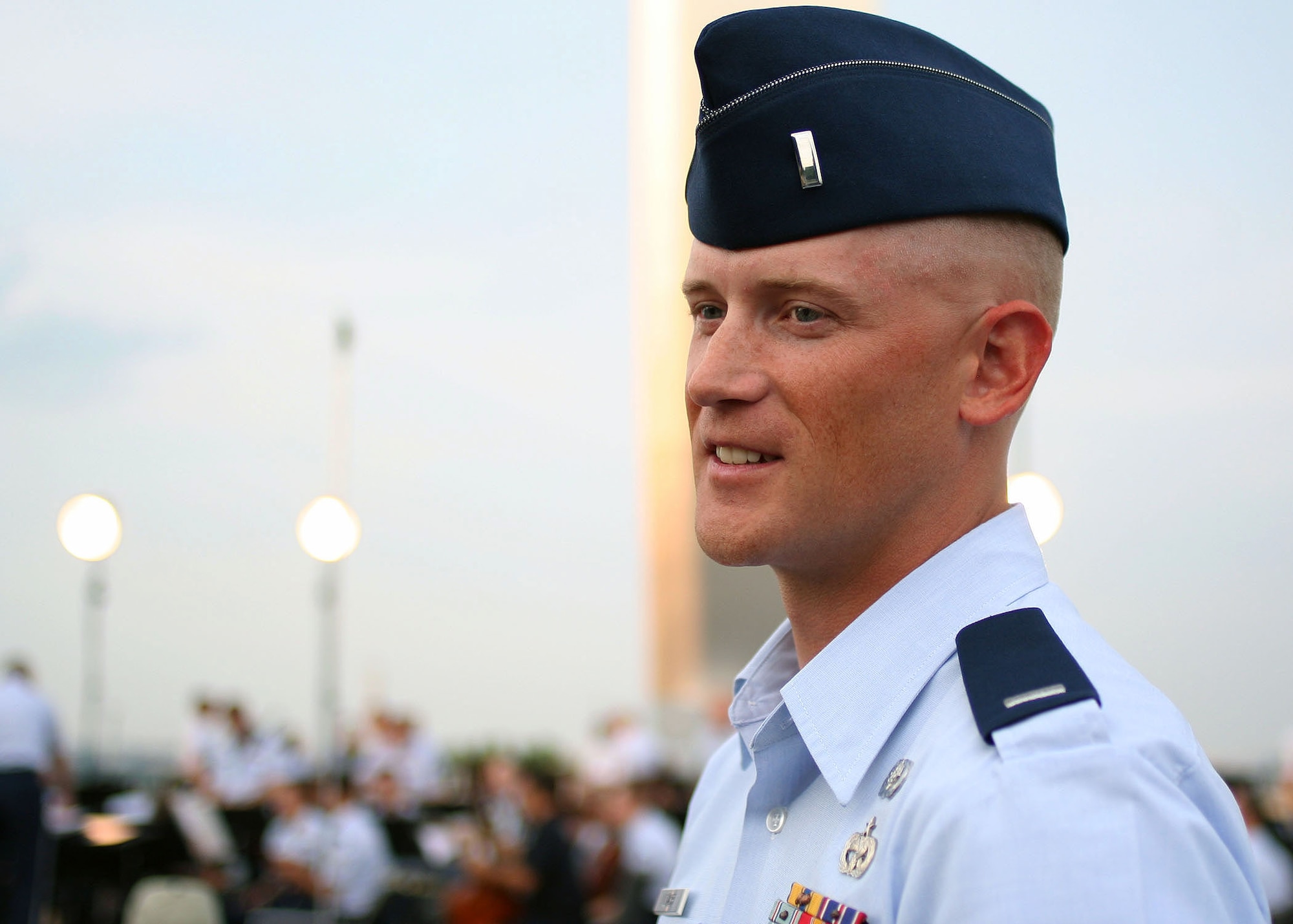 First Lt. Michael Lemoire, U.S. Air Force Honor Guard flight commander, participates in a rare experience of conducting the U.S. Air Force Band concert ensemble, Aug. 3, at the Air Force Memorial in Arlington Va.  Lemoire set aside his honor guard duties for an evening to put his musical education and background to the test while leading the 53 piece group ensemble. (Courtesy photo by Amelia Harrington)  