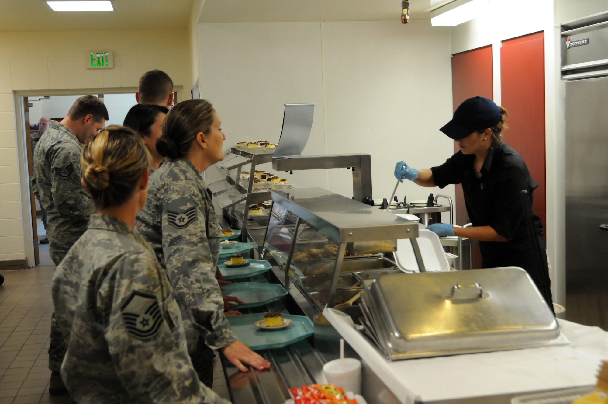 A food service worker serves wing members during lunch Aug. 5.  The new contract, awarded in late July, brings a new crew of civilian workers who will assist Services personnel with the preparation and serving of more than 1,000 meals each drill weekend.