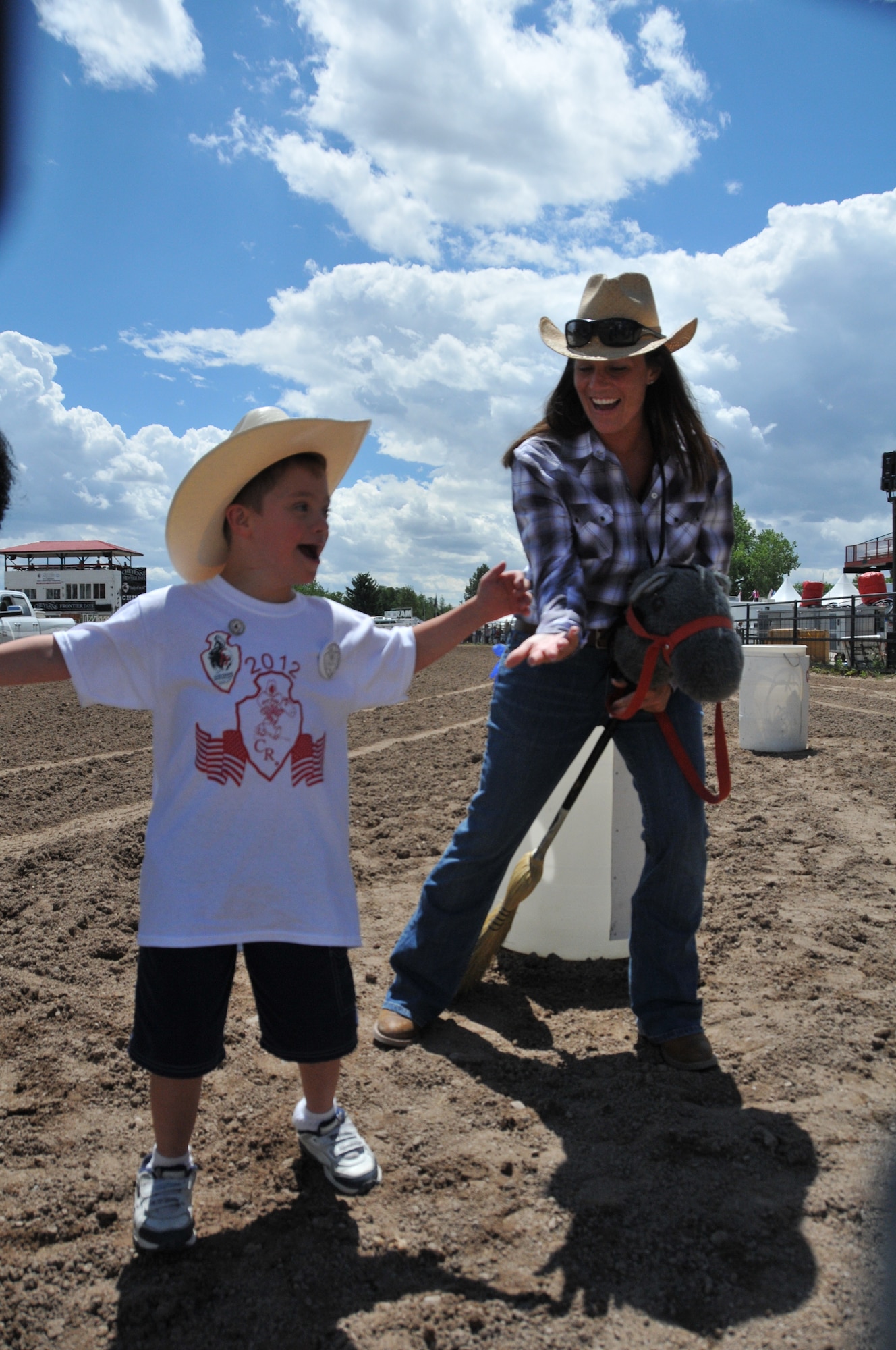 Staff Sgt. Heidi Valdez, 153rd Medical Group health technician, cheers for Ashton, a contestant at The Challenge Rodeo at Cheyenne Frontier Days, July 25, 2012. Valdez volunteered for the first year as a cowboy medic assisting rodeo contestants with injuries. (U.S. Air Force photo by 1st Lt. Rusty Ridley)


