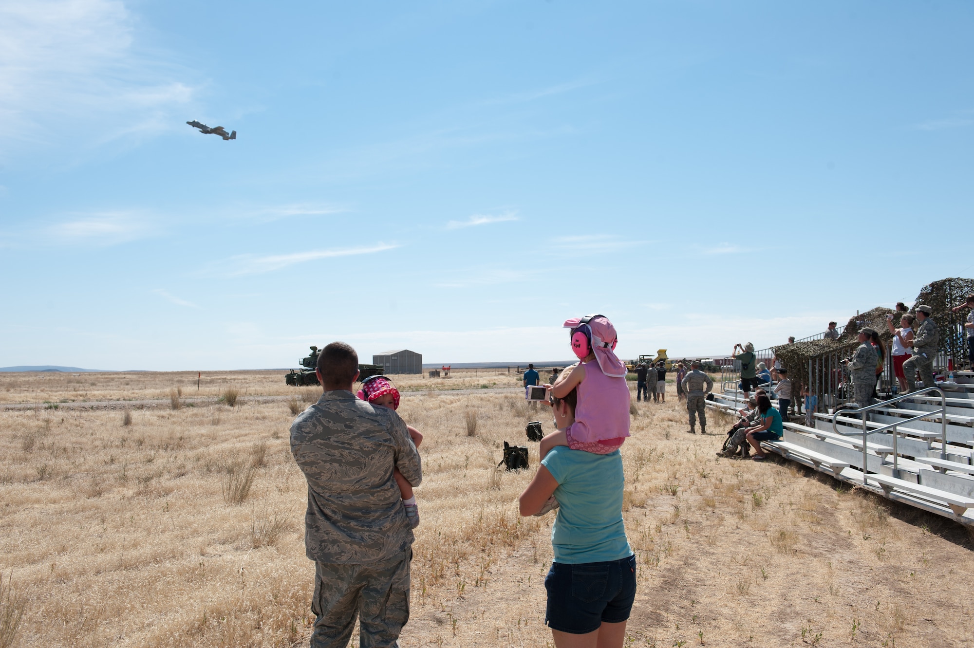 Maj. Shawn Scott and his family watch an A-10 Thunderbolt II make a strafing pass at Saylor Creek range Aug. 5 as part of the 124th Air Support Operations Squadron's Kin Appreciation Day. During the event family and loved ones were able to see up close the equipment joint terminal attack controllers use in training and combat, as well as eat lunch and watch A-10 Thunderbolt II's conduct strafing runs with their GAU-8 gatling cannon.



