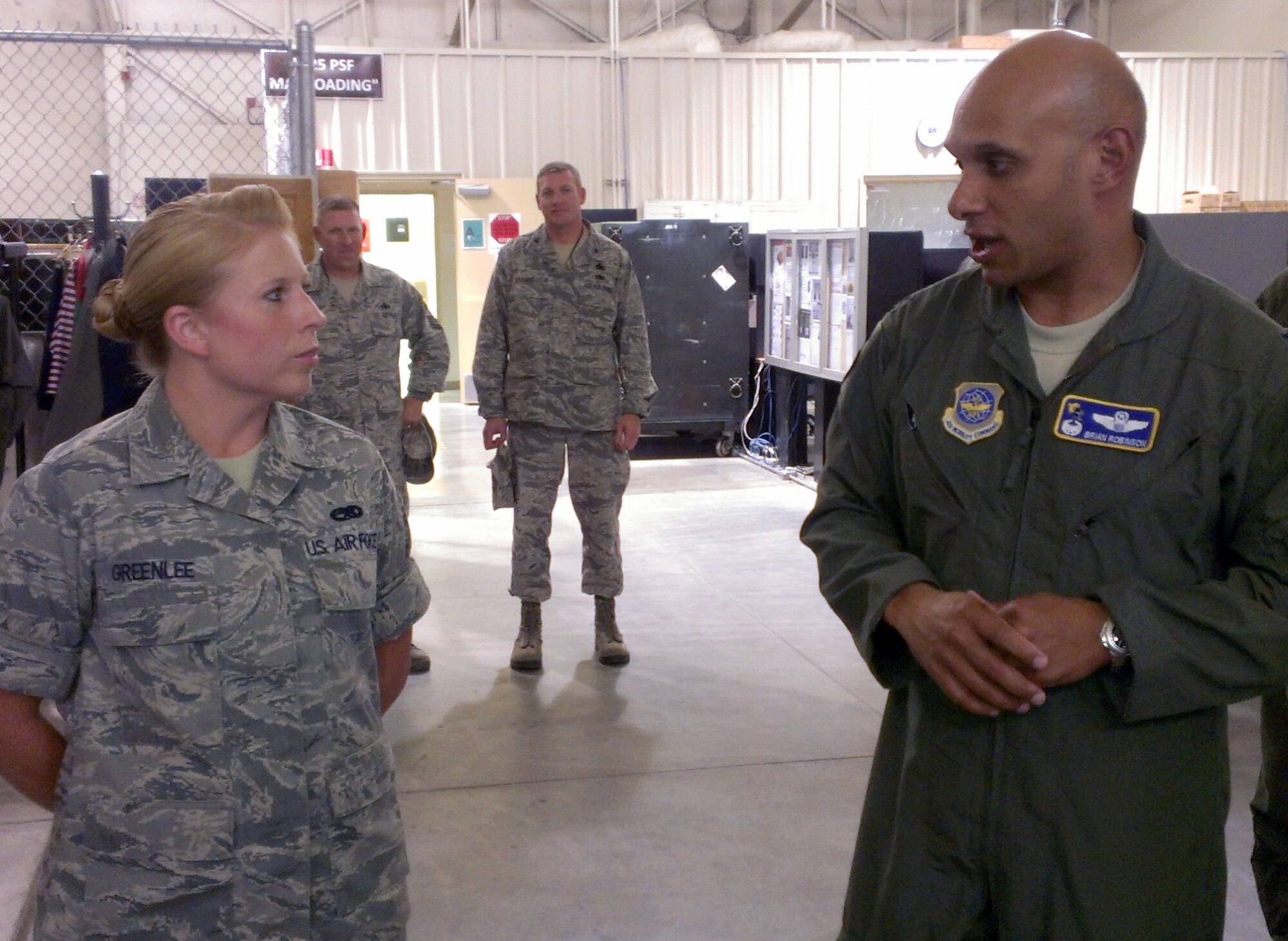 Col. Brian Robinson, 19th Airlift Wing commander, congratulates Airman 1st Class Dana Greenlee, a 19th Component Maintenance Squadron hydraulics journeyman, for her selection as Combat Airlifter of the Week Aug. 7, 2012, at Little Rock Air Force Base, Ark. Greenlee a West Hickory, Pa., native, hosted a Niagara Falls Air National Guard Team that consisted of seven non commissioned officers for training on the brake modification process. (U.S. Air Force photo by Master Sgt. Bryan Bissonnette) 