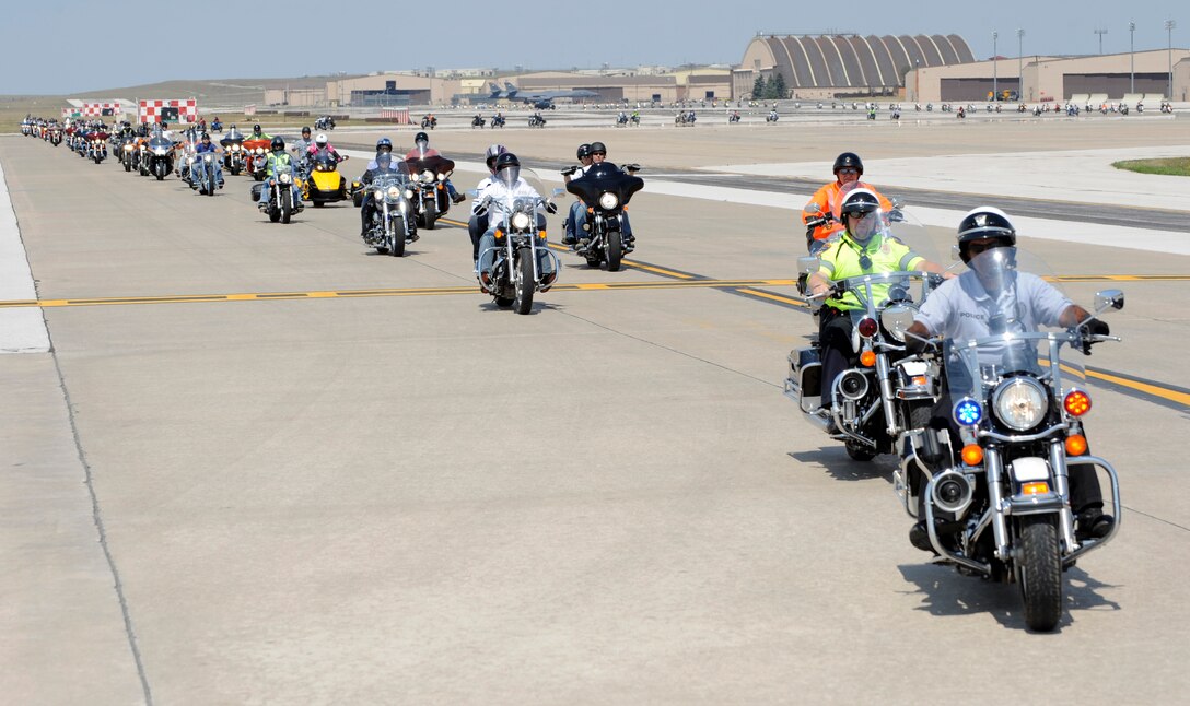 Local police officers escort 2012 Dakota Thunder Run participants down the flightline at Ellsworth Air Force Base, S.D., Aug. 7, 2012. The run was hosted by Ellsworth's own Dakota Thunder Motorcycle Club and drew a crowd of more than 450 active-duty servicemembers, veterans, Ellsworth civilian employees and their family members. (U.S. Air Force photo by Airman Ashley J. Cass/Released)