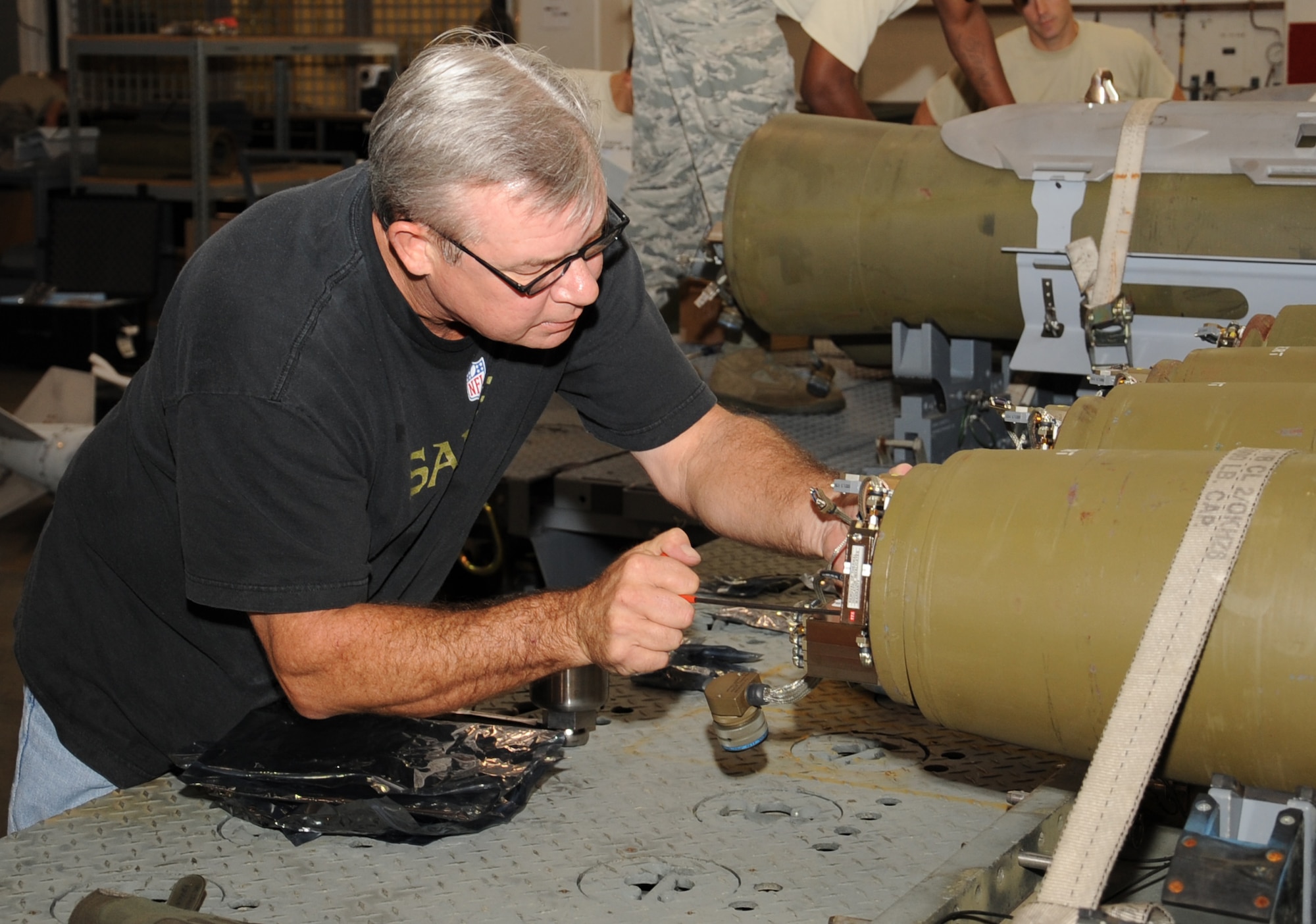 John Mikelatis, Air Force Life Cycle Management Center Joint Direct Attack Munition program office, works on a JDAM Guided Bomb Unit 38 during the Weapons Standards Evaluation Program 12-21 exercise Combat Hammer on Barksdale Air Force Base, La., Aug. 9. The exercise is a way to ensure weapons used in the Area of Responsibility are fully functioning and mission capable to complete the task at hand. (U.S. Air Force photo/Senior Airman Sean Martin)(RELEASED)