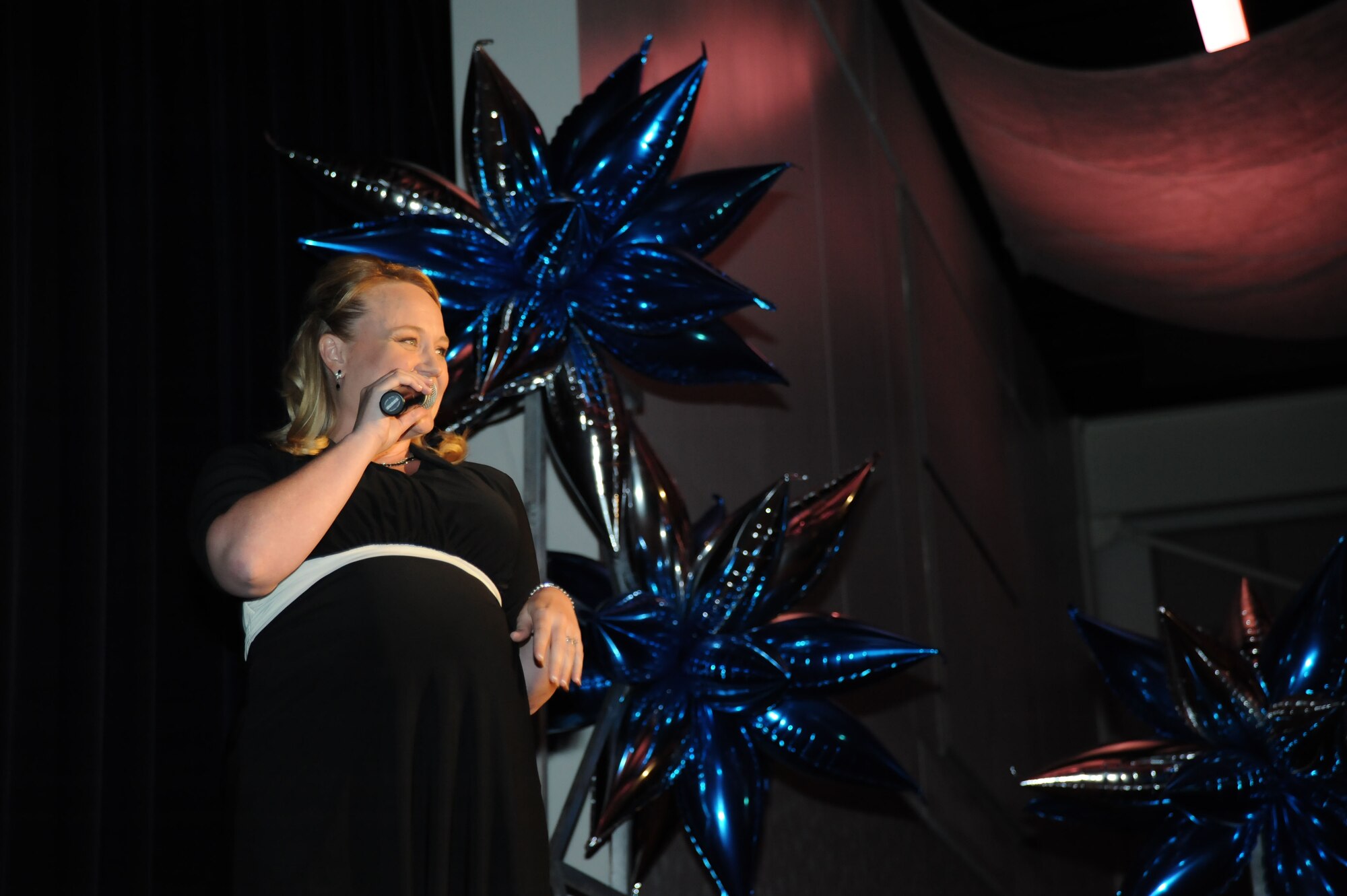 Melissa Ghandour sings in the Air Mobility Command Icon competetition August 11, 2012, McConnell Air Force Base, Kan. The event is held to showcase the talents of the Airmen and family members in AMC, and top performing Airman from each participating base will go on to the finals at Scott Air Force Base, Ill., and compete for a chance to audition for Tops in Blue, the premiere Air Force band. (U.S. Air Force photo/Airman 1st Class Victor J. Caputo)