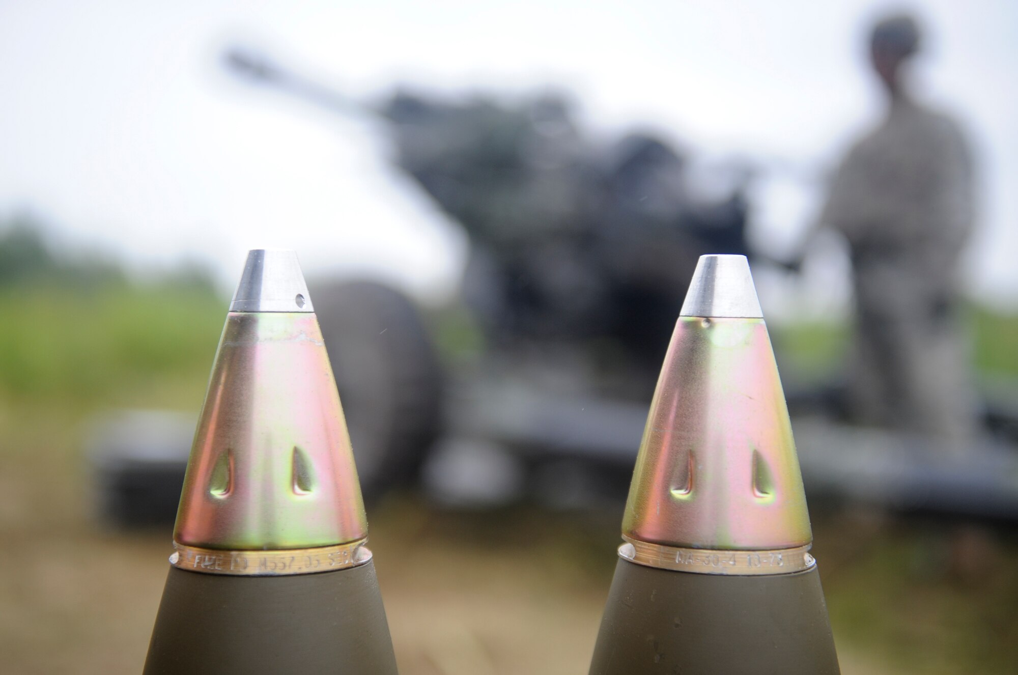 105mm ammunition is ready to be fired during the 10th Mountain Division’s Mountain Peak exercise at Fort Drum, N.Y., July 26, 2012. The M119 Howitzer fires 105mm rounds and has a maximum rate of fire of six rounds per minute for two minutes. (U.S. Air Force photo by Airman 1st Class Douglas Ellis/Released)
