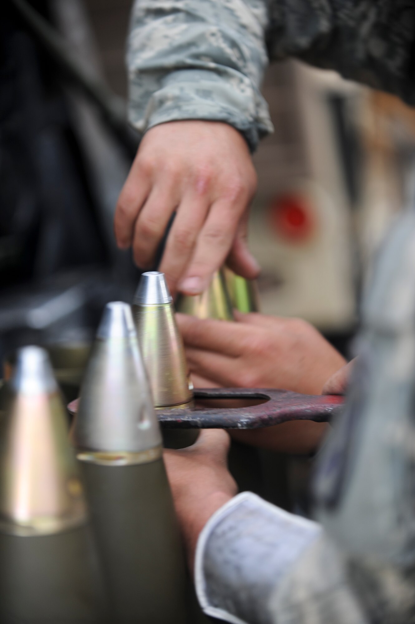 U.S. Army soldiers from the 10th Mountain Division, 3rd Battalion, 6th Field Artillery, Alpha Battery Company, 2nd platoon prepare 105mm rounds during exercise Mountain Peak at Fort Drum, N.Y., July 26, 2012. Soldiers and Airmen trained during Mountain Peak to prepare for future deployments together downrange. (U.S. Air Force photo by Airman 1st Class Douglas Ellis/Released)
