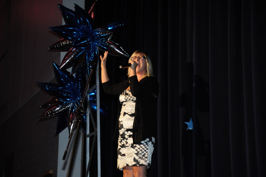 Erica Tillman sings in the Air Mobility Command Icon competition August 11, 2012, McConnell Air Force Base, Kan. The event is held to showcase the talents of the Airmen and family members in AMC, and the top performing Airman from each participating base will go on to the finals at Scott Air Force Base, Ill., and compete for a chance to audition for Tops in Blue, the premiere Air Force band. (U.S. Air Force photo/Airman 1st Class Victor J. Caputo) 

