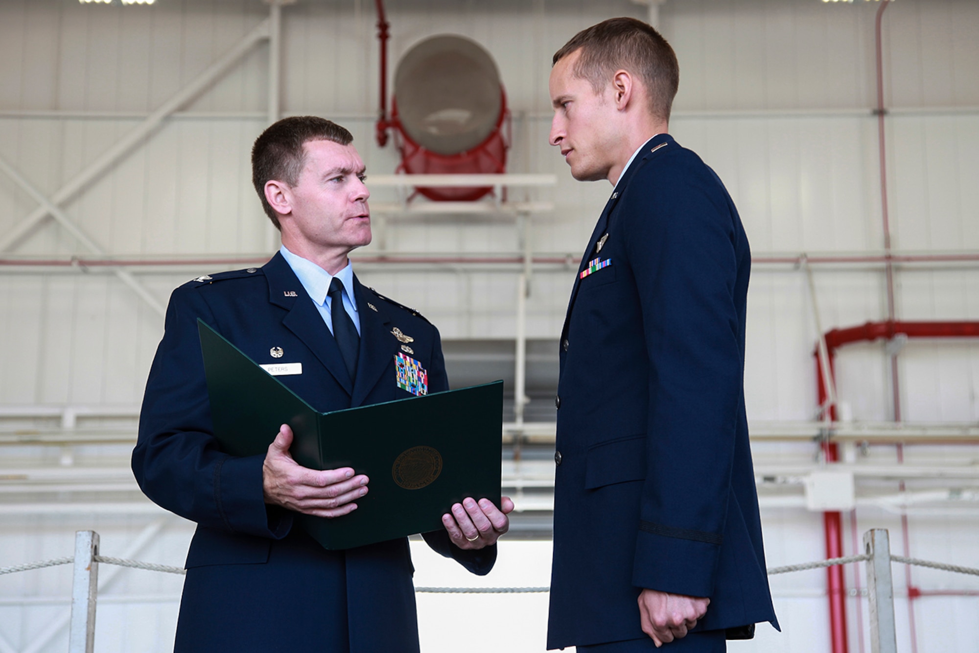 Col. Craig Peters, 911th Airlift Wing commander, presents the prestigious Orville Wright Achievement Award to 2nd Lt. Wesley Baranowski, 758th Airlift Squadron, during the commander’s call held at hangar 129, Aug. 12, 2012. Baranowski’s performance during the Joint Specialized Undergraduate Pilot Training was superb in all phases of the training program in which he accomplished to exemplify the highest standards established by the award. The award is given by the Daedalian foundation and is dedicated in ensuring that the United States military will always be preeminent in air and space, encouraging flight safety, promoting an esprit de corps, encouraging the adoption of the military as a career, and supporting military members in specialized higher education through the establishment of scholarships. (U.S. Air Force photo by Tech. Sgt. Ralph Van Houtem/Released)