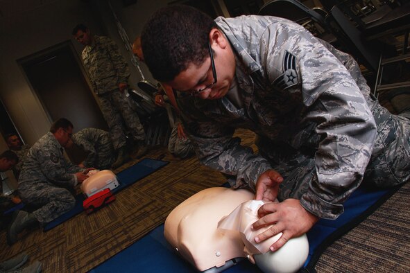 Senior Airman Luis Adorno Martinez, 911th Airlift Wing Maintenance Squadron aircraft structural maintainer, performs the head-tilt chin-lift on the first-aid dummy “Little Anne” during a CPR/AED certifying class held at building 220, Aug. 10, 2012.  Military personnel from the Aeromedical Staging Squadron instructed 16 Airmen on the many steps of cardiopulmonary resuscitation in compliance with the American Heart Association. (U.S. Air Force photo by Senior Airman Justyne Obeldobel/Released)