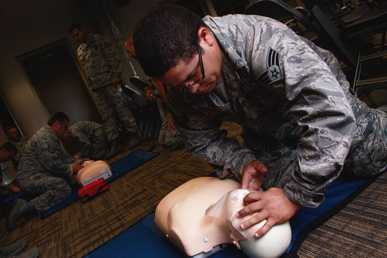 Senior Airman Luis Adorno Martinez, 911th Airlift Wing Maintenance Squadron aircraft structural maintainer, performs the head-tilt chin-lift on the first-aid dummy “Little Anne” during a CPR/AED certifying class held at building 220, Aug. 10, 2012.  Military personnel from the Aeromedical Staging Squadron instructed 16 Airmen on the many steps of cardiopulmonary resuscitation in compliance with the American Heart Association. (U.S. Air Force photo by Senior Airman Justyne Obeldobel/Released)