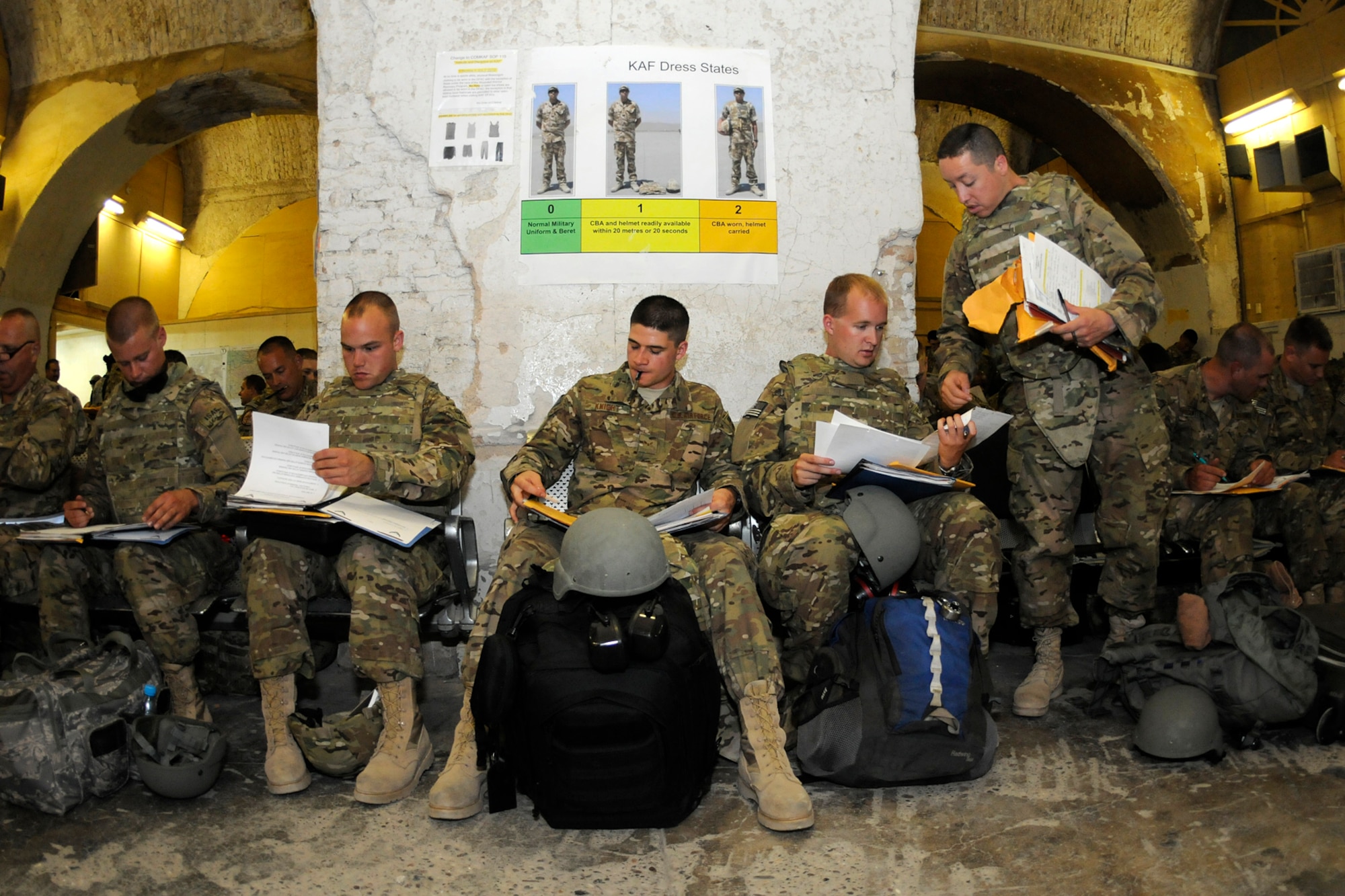 Airmen from the Minnesota Air National Guard begin their in-processing paperwork at the PAX terminal at Kandahar Airfield, Afghanistan, Aug. 10, 2012. Personnel are deployed from the Minnesota Air National Guard's 148th Fighter Wing in support of Operation Enduring Freedom. Bull Dog F-16’s, pilots, and support personnel began their Air Expeditionary Force deployment in mid-August to take over flying missions for the air tasking order and provide close air support for troops on the ground in Afghanistan. (Air Force photo by Tech. Sgt. Stephen Hudson, 169th Fighter Wing/Public Affairs.)