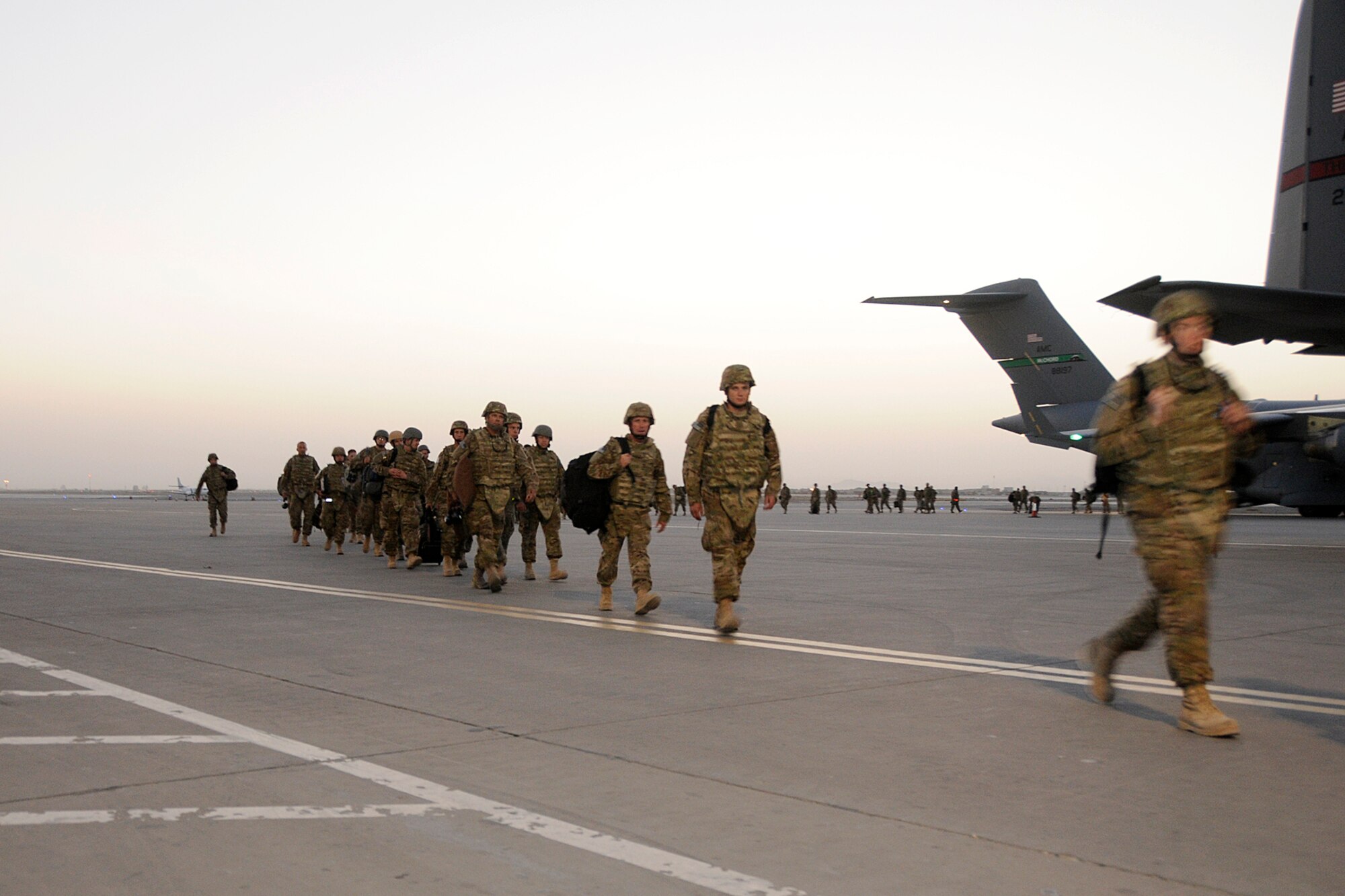 Airmen from the Minnesota Air National Guard disembark a C-17 on the ramp at Kandahar Airfield, Afghanistan, on Aug. 10, 2012. Personnel are deployed from the Minnesota Air National Guard's 148th Fighter Wing in support of Operation Enduring Freedom. Bull Dog F-16’s, pilots, and support personnel began their Air Expeditionary Force deployment in mid-August to take over flying missions for the air tasking order and provide close air support for troops on the ground in Afghanistan.  (Air Force photo by Tech. Sgt. Stephen Hudson, 169th Fighter Wing/Public Affairs.)