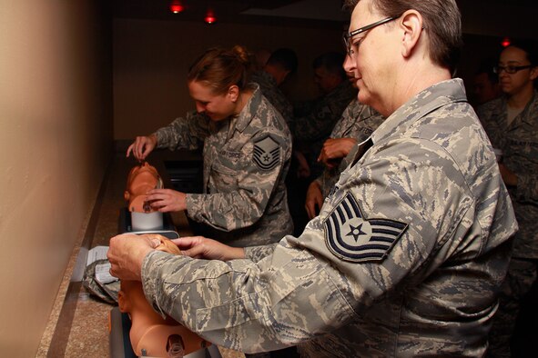 Tech. Sgt. Eleanor Weaver, a 911th Airlift Wing Mission Support Group knowledge operations manager, practices to insert a nasopharyngeal airway into a first-aid dummy head during a Self-Aid and Buddy Care class held at the recreation center, building 213, Aug. 9, 2012.  During this class, Weaver and 30 fellow Airmen learned the proper use of SABC items such as, the Nasopharyngeal Airway, the Combat Application Tourniquet, and Combat Gauze.  Airmen were also trained on the proper techniques of controlling blood loss and how to correctly transport a victim in different combat environments. (U.S. Air Force photo by Senior Airman Justyne Obeldobel/Released)