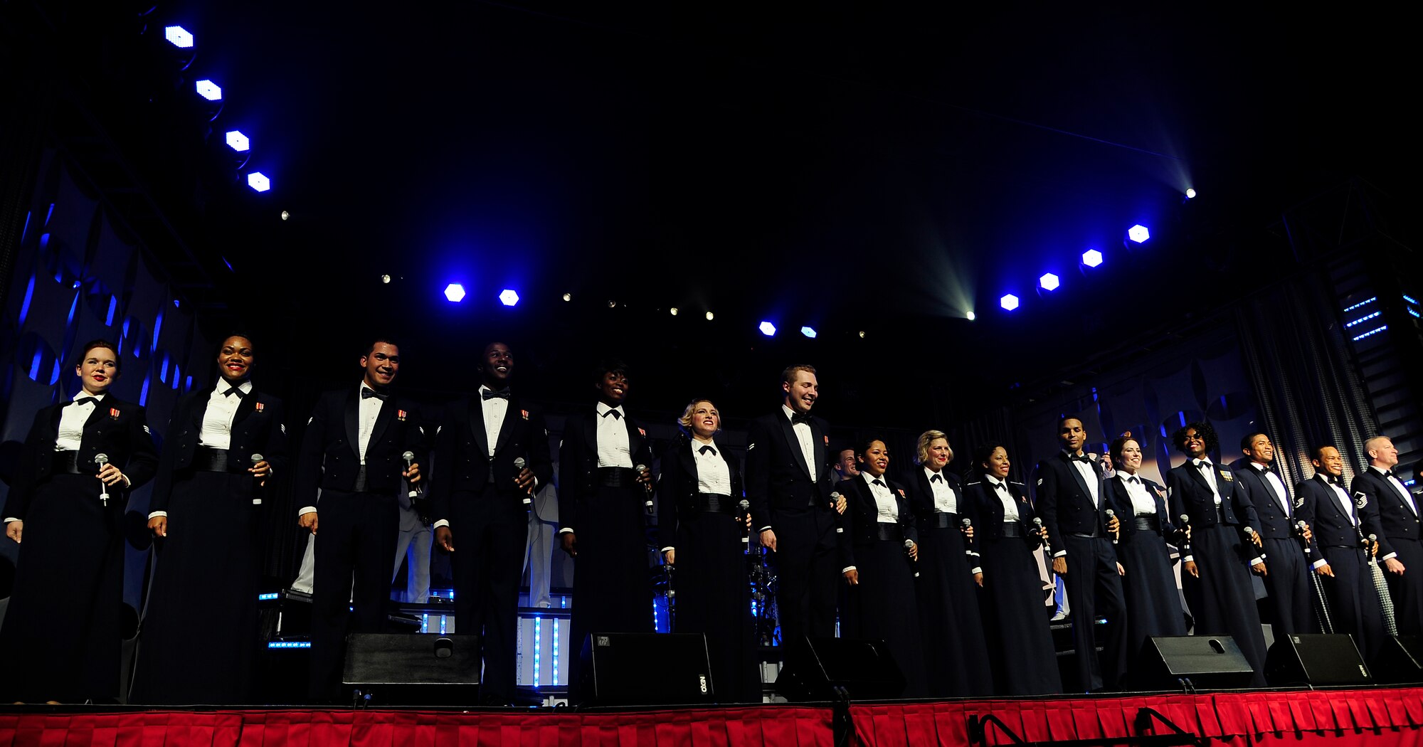 Receiving a standing ovation, Tops In Blue end their show in uniform at the University of Central Missouri in Warrensburg, Mo., Aug. 9, 2012. The two hour concert was targeted for Whiteman Air Force Base service members and their families, but fans from the local communities were welcome also. Tops In Blue travel throughout the United States and to more than 20 countries during their 10-month tour each year.(U.S. Air Force photo/Senior Airman Cody H. Ramirez)