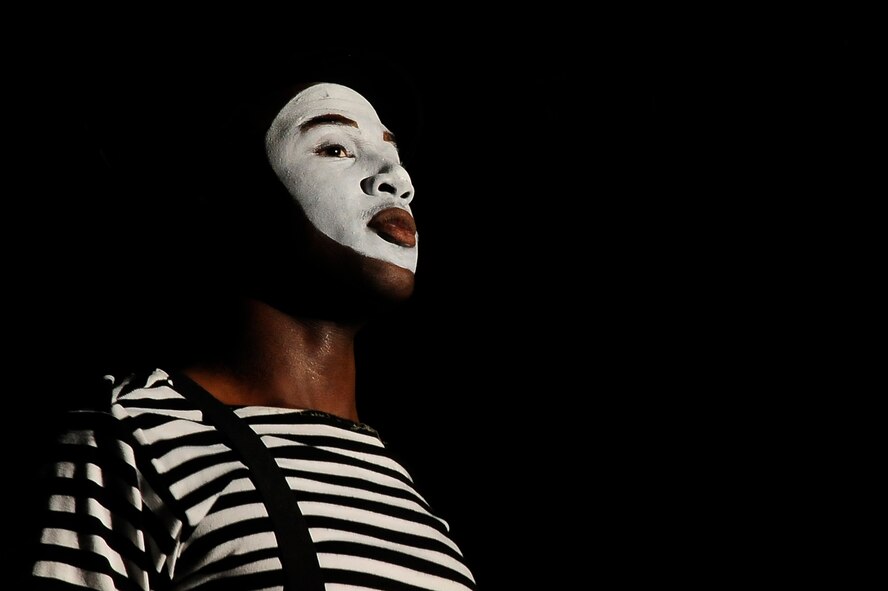 A Tops In Blue member performs a mime routine to Bruno Mar's "Grenade" at the University of Central Missouri in Warrensburg, Mo., Aug. 9, 2012. The show was a majority of song and dance, but the silent skit showed the entertainment team's talent and diversity. (U.S. Air Force photo/Senior Airman Cody H. Ramirez)
