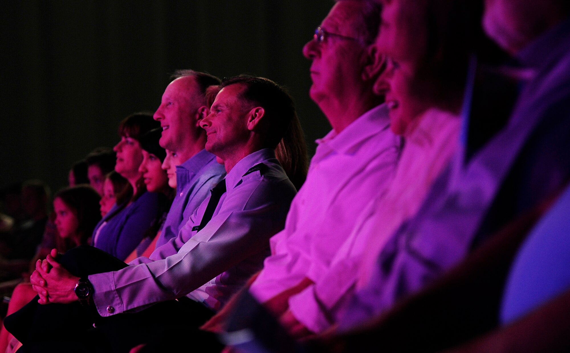 Col. Robert Spalding(center), 509th  Bomb Wing Vice Commander from Whiteman Air Force Base, enjoys a Tops In Blue performance at the University of Central Missouri Aug. 9, 2012. Spalding, the host for the night, started the show by thanking local sponsors and the Tops In Blue team for supporting the Whiteman community with entertainment for the night. (U.S. Air Force photo/Senior Airman Cody H. Ramirez)