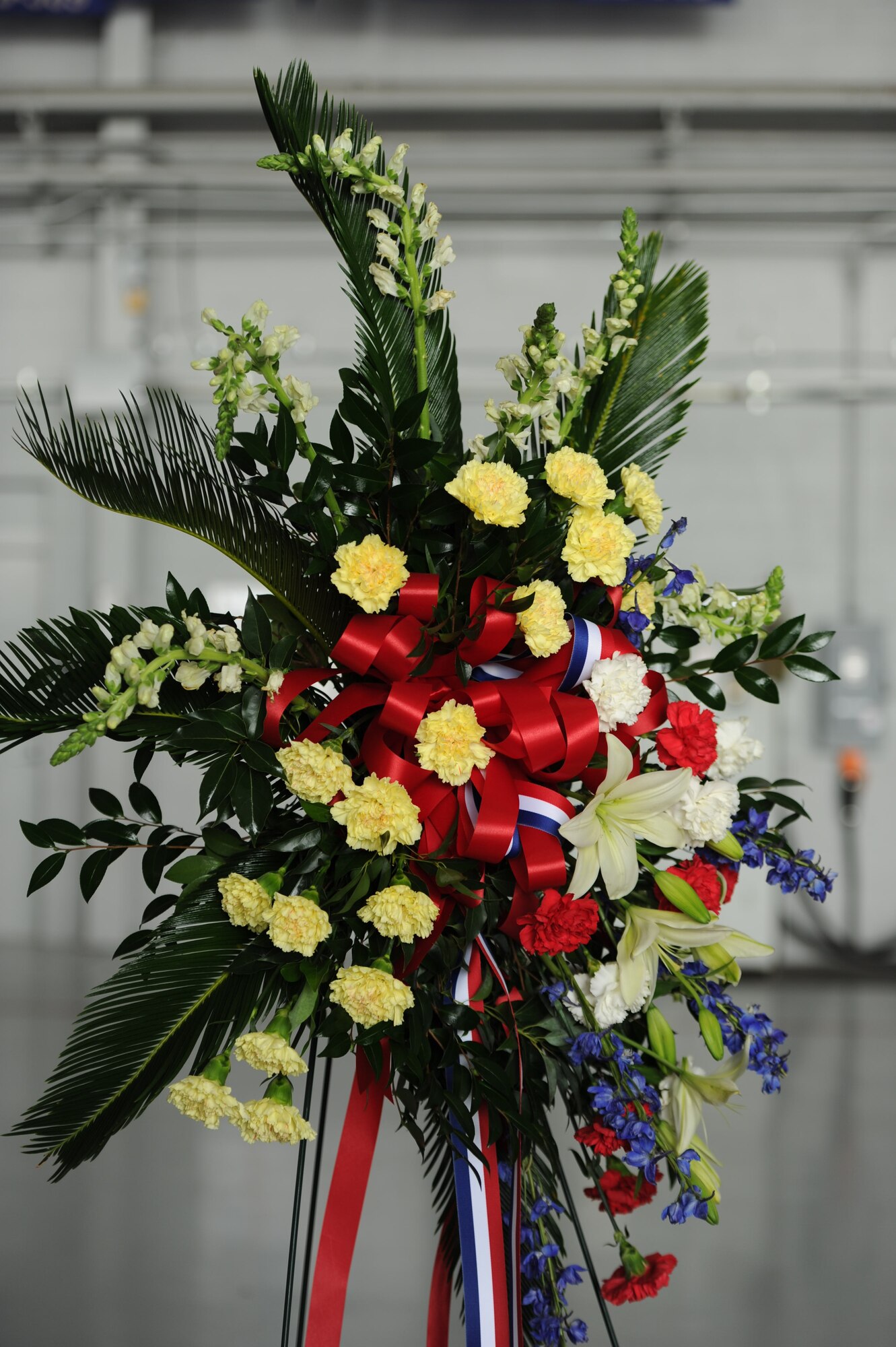 A wreath stands in the Commando Hangar during a memorial ceremony commemorating the 10th anniversary of the Talon 13 and Chariot 55 missions on Hurlburt Field, Fla., Aug. 10. Gold Star families of the fallen Airmen were presented a wreath in honor of their family's sacrifice. (U.S. Air Force photo/ Airman 1st Class Naomi M. Griego)