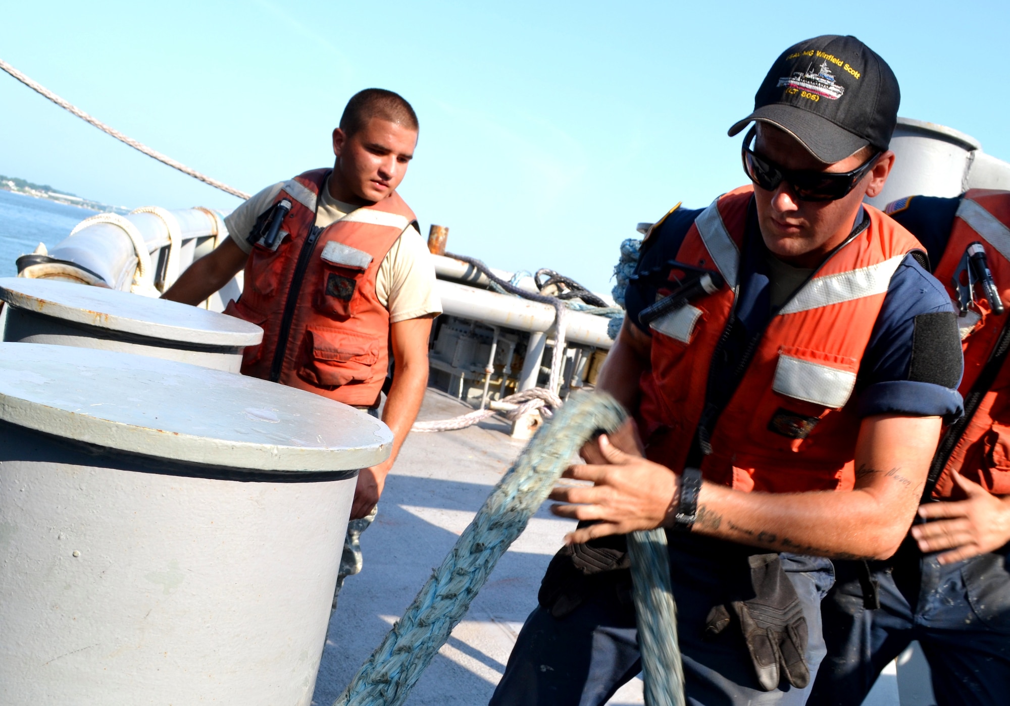 U.S. Army Spec. Adam Kagnhieser, a watercraft operator for the Maj. Gen. Winfield Scott, Large Tug 805, strengthens the hold of a synthetic line tighter to the tug, towing Landing Craft Utility 2006 during a training exercise at U.S. Coast Guard Training Center Yorktown, Va., Aug. 3. Synthetic lines like this are rated to hold nearly 300,000 lbs. (U.S. Army photo by Sgt. Edwin Rodriguez/Released)