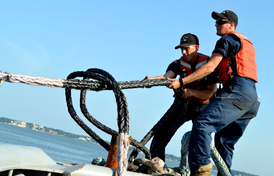 U.S. Army Spec. Alexander Meese, and Spc. Adam Kagnhieser, watercraft operators for the Maj. Gen. Winfield Scott, Large Tug 805, tighten the hold of the Landing Craft Utility 2006 to their tug as they get underway from U.S. Coast Guard Training Center Yorktown, Va., Aug. 3. Dubbed one of the most dangerous jobs in the watercraft field, working on a tug isn’t for the faint of heart. (U.S. Army photo by Sgt. Edwin Rodriguez/Released)