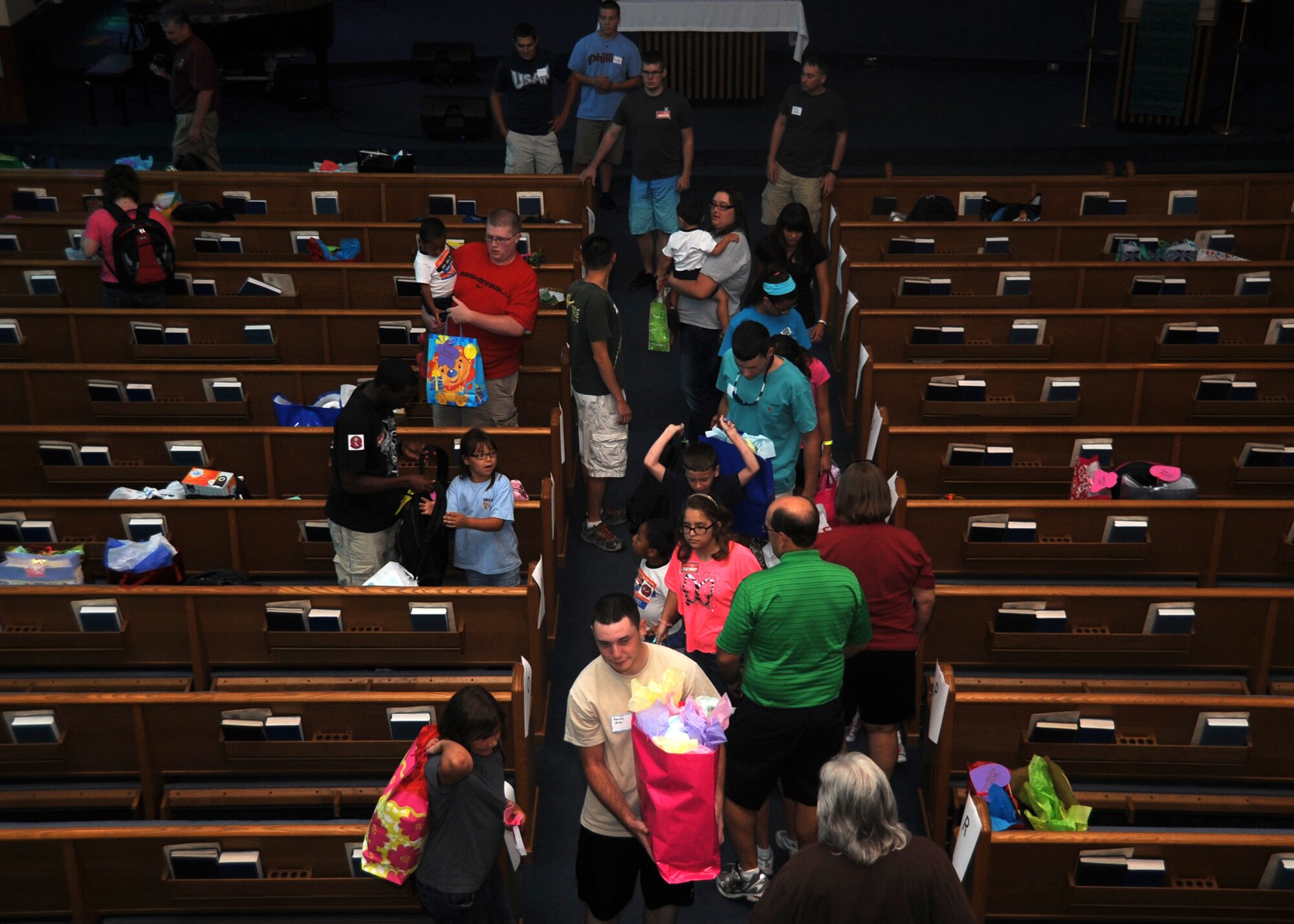 ALTUS AIR FORCE BASE, Okla. – Children from the Tipton Children’s Home collect gifts at the base chapel during the Christmas in August event Aug. 11, 2012. Base personnel gave clothes and school supplies for the upcoming school year. (U.S. Air Force photo by Airman 1st Class Franklin R. Ramos / 97th Air Mobility Wing / Released)