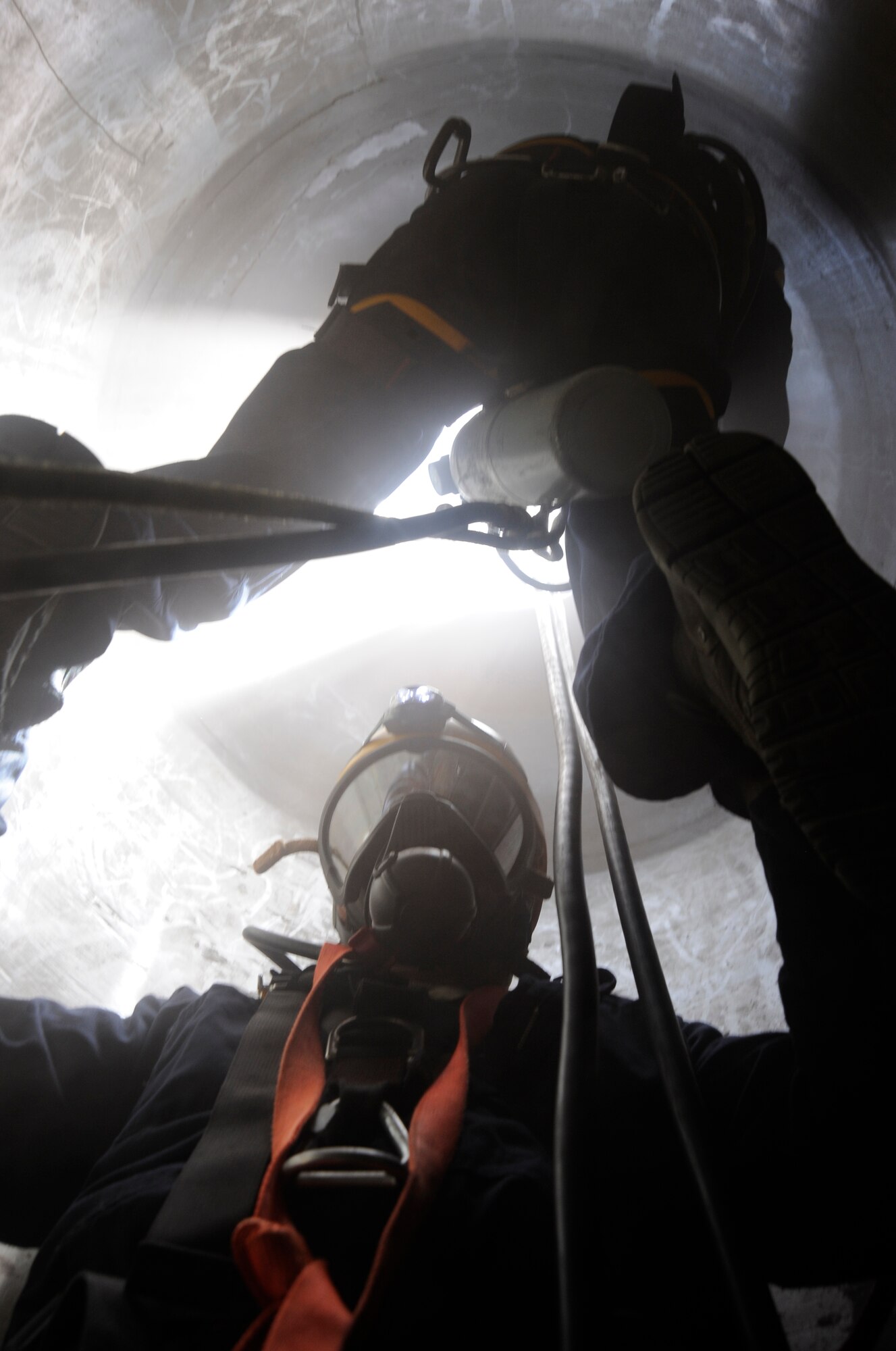 Staff Sgt. Neal Krysinski, firefighter crew chief, and Airman 1st Class Joel Rosado-Chavez, firefighter, with the 6th Civil Engineer Squadron, participate in confined space rescue training, a component of the Rescue Technician coursem, at MacDill Air Force Base, Fla., Aug. 8, 2012. The week-long course included classroom instruction and hands-on evaluations for rope rescue, surface water rescue awareness, confined space rescue, and national incident management system familiarization. (U.S. Air Force photo by Airman 1st Class Melanie Bulow-Kelly/released/ cropped to point of interest)