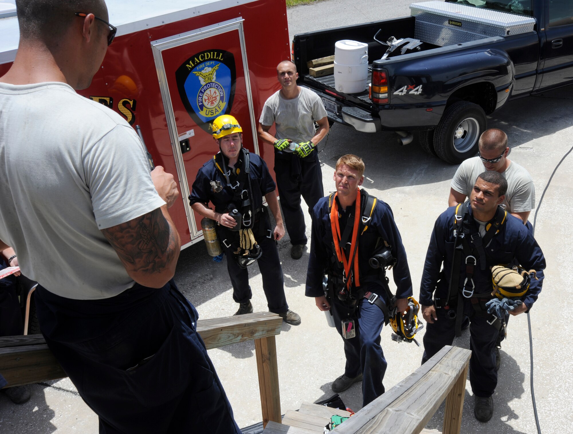 Staff Sgt. Joshua Reyes, 6th Civil Engineer Squadron firefighter crew chief, briefs the firefighters prior to a confined space examination as part of the Rescue Technician I course at MacDill Air Force Base, Fla., Aug. 8, 2012. The week-long course included classroom instruction and hands-on evaluations for rope rescue, surface water rescue awareness, confined space rescue, and national incident management system familiarization. (U.S. Air Force photo by Airman 1st Class Melanie Bulow-Kelly/released/ cropped to point of interest)