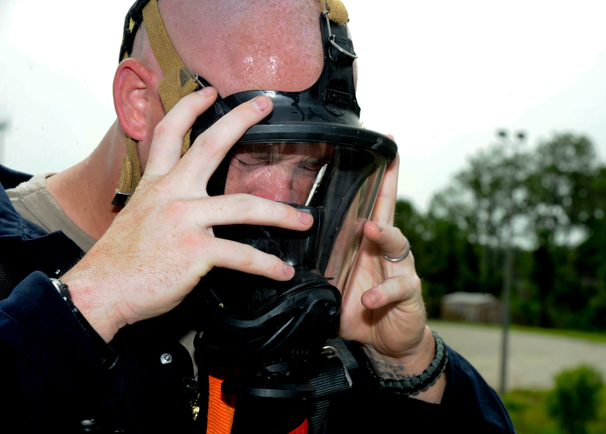 Staff Sgt. Dallas Harper-Staub, 6th Civil Engineer Squadron firefighter crew chief, removes his face mask after partaking in the confined space training at MacDill Air Force Base, Fla., Aug. 8, 2012. Harper-Staub participated in a week-long Rescue Technician I course consisting of four training elements. (U.S. Air Force photo by Airman 1st Class Melanie Bulow-Kelly/released/ cropped to point of interest)