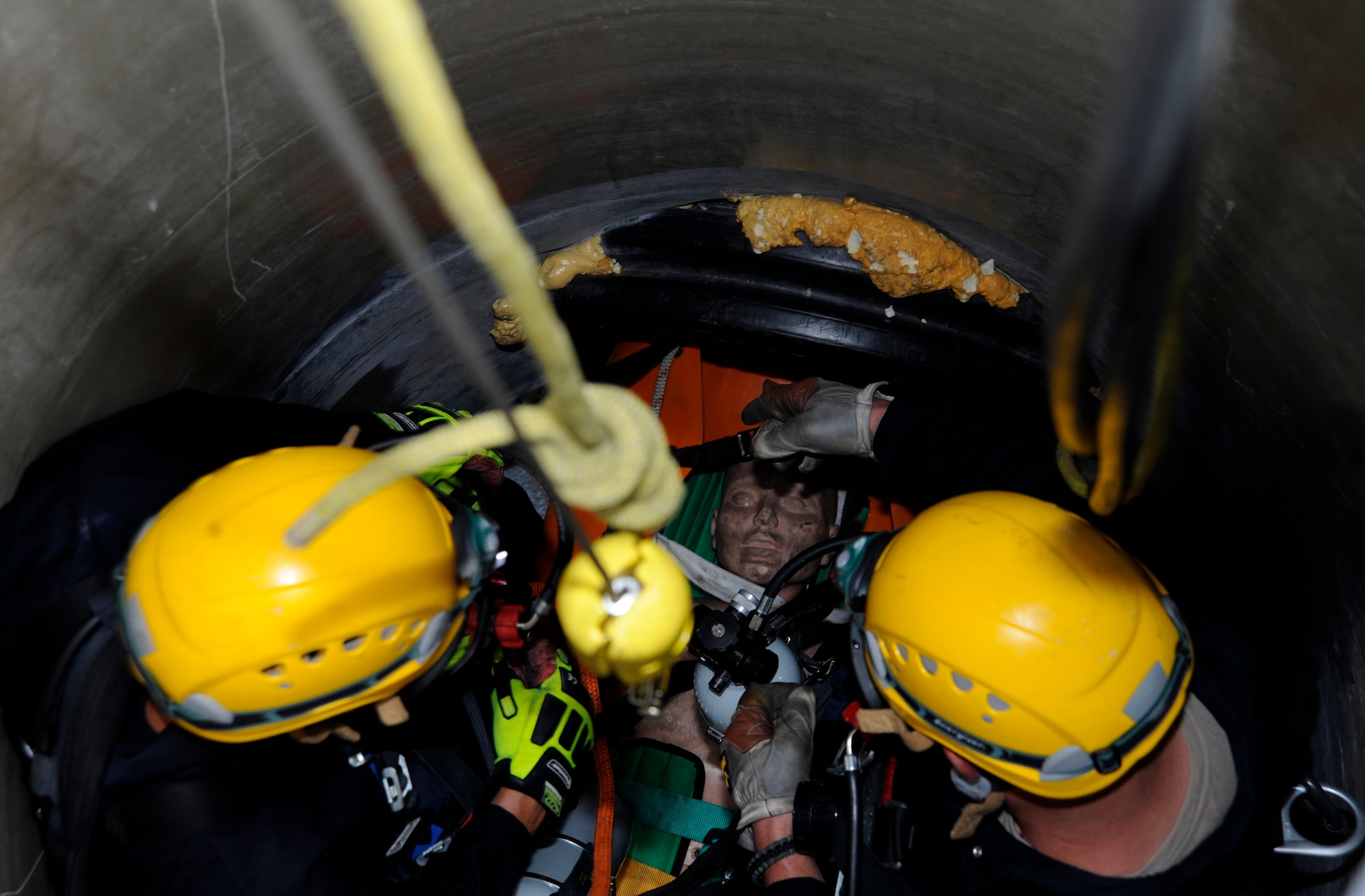 Airman 1st Class Jesse Flagle, 45th Civil Engineer Squadron firefighter, Patrick Air Force Base, Fla., and Staff Sgt. Dallas Harper-Staub, 6th Civil Engineer Squadron firefighter crew chief, ensure a training mannequin is properly secured before it’s lifted to safety during the Rescue Technician I course at MacDill AFB, Fla., Aug. 8, 2012. This exercise was part of a final hands-on exam required to pass the United States Air Force Europe Fire Academy Rescue Technician I course. (U.S. Air Force photo by Airman 1st Class Melanie Bulow-Kelly/released/ cropped to point of interest)