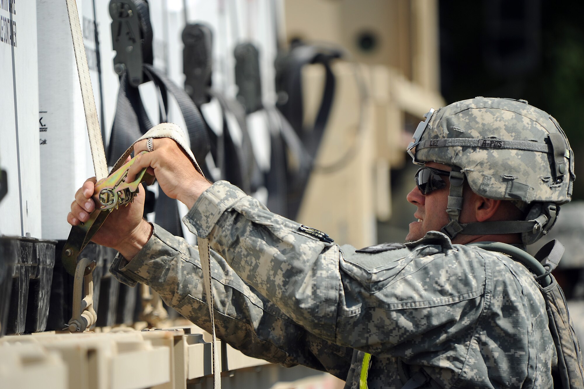 U.S. Army Sgt. Matthew Lei, assigned to the 565th Quartermaster Company, Fort Hood, Texas, unhooks cargo straps on a M1088 tractor truck at the Indiana National Guard Armory, Scottsburg, Ind., during Exercise Vibrant Response, Aug 2, 2012. Exercise Vibrant Response is a training event for the Defense Chemical, Biological, Radiological and Nuclear Response Force.  (Official DOD photo by U.S. Air Force Tech. Sgt. Tony Tolley/Released)