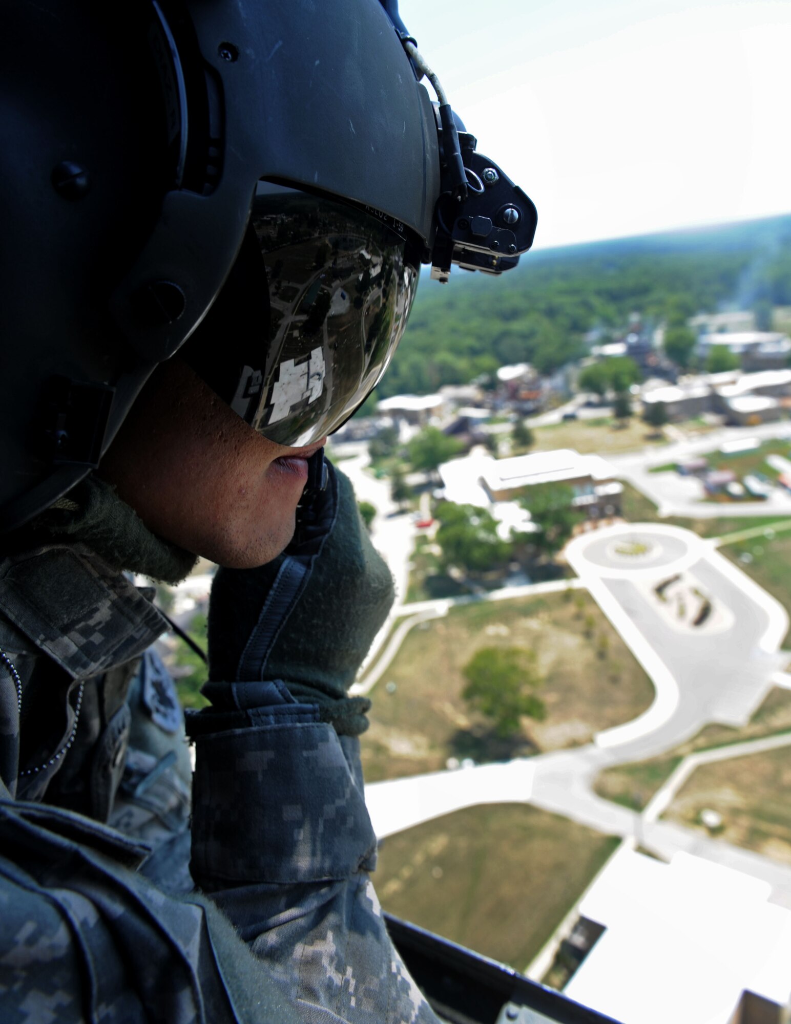A crew chief from the 214th Aviation Regiment conducts an aerial fire suppression mission using a Bambi Bucket during Exercise Vibrant Response 13 at Muskatatuck Urban Training Center, Ind., Aug 2, 2012. Exercise Vibrant Response is a training event for the DCRF, which focused on Department of Defense support of civil authorities in a consequence management role. (Official DOD photo by U.S. Air Force Staff Sgt. Ashley Reed/Released)