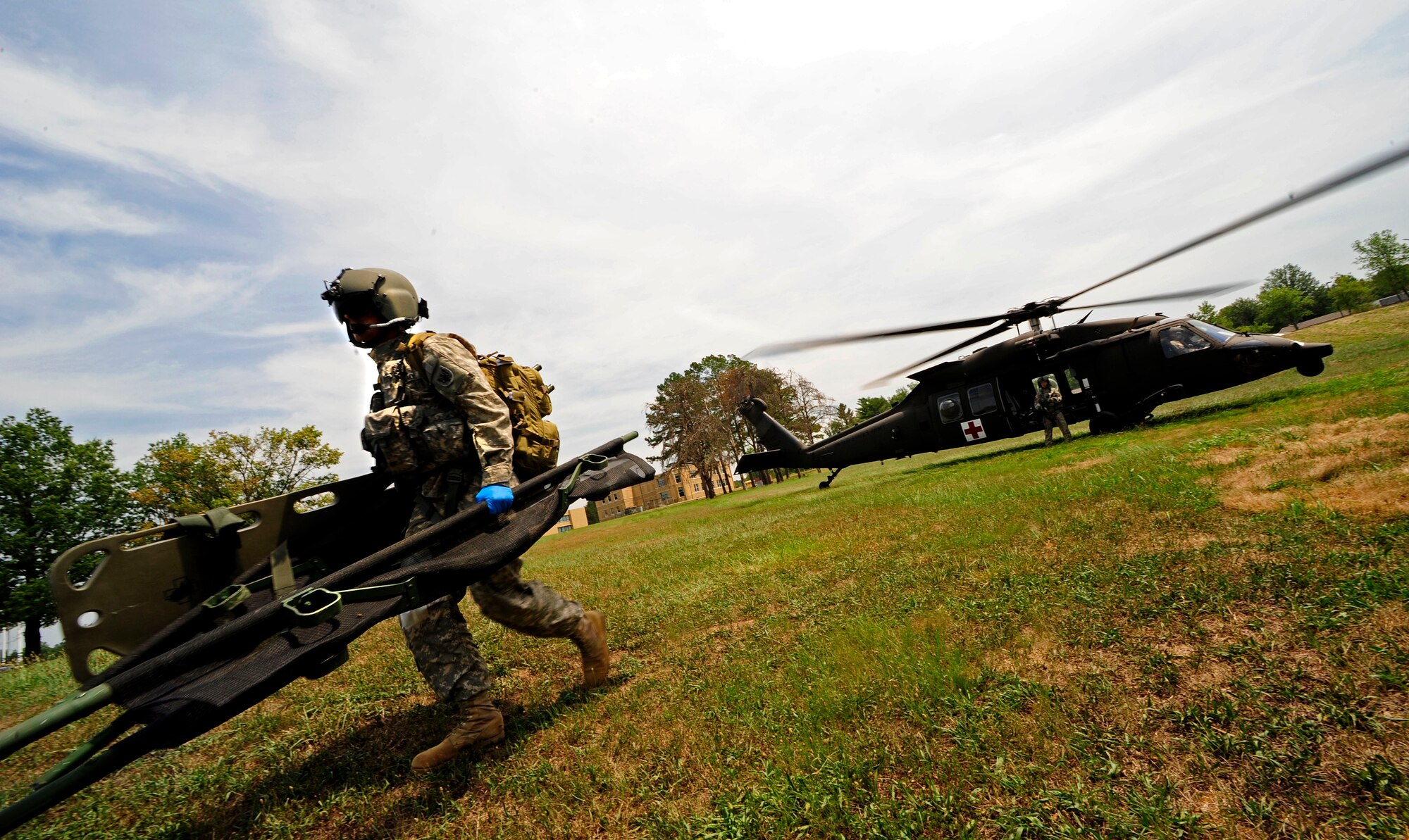 U.S. Army Staff Sgt. Scott Graham, a medic with the 214th Aviation Regiment Air Ambulance, moves to extract a patient during a medical evacuation mission in support of Exercise Vibrant Response 13 at Camp Atterbury, Ind., July 31, 2012. Joint Task Force-Civil Support and the Response Force responded to a simulated five kiloton nuclear device that was detonated in a major U.S. city. (Official DOD photo by U.S. Air Force Staff Sgt. Ashley Reed/Released)