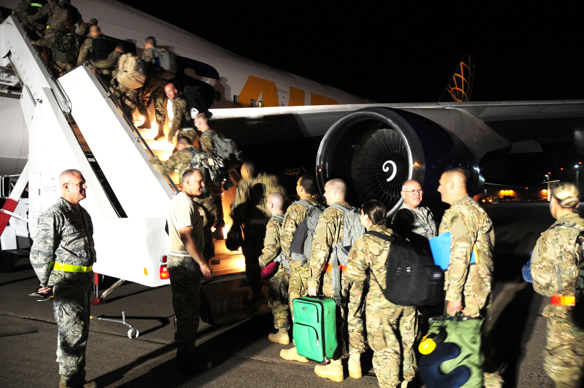 Approximately 150 members of the 148th Fighter Wing board an aircraft to Kandahar Air Field, Afghanistan on Saturday Aug. 11, 2012.  Approximately 300 Bulldogs are deploying in support of Operation Enduring Freedom for two months, and are scheduled to provide close air support for coalition ground forces.  (National Guard photo by Tech. Sgt. Scott G. Herrington.)