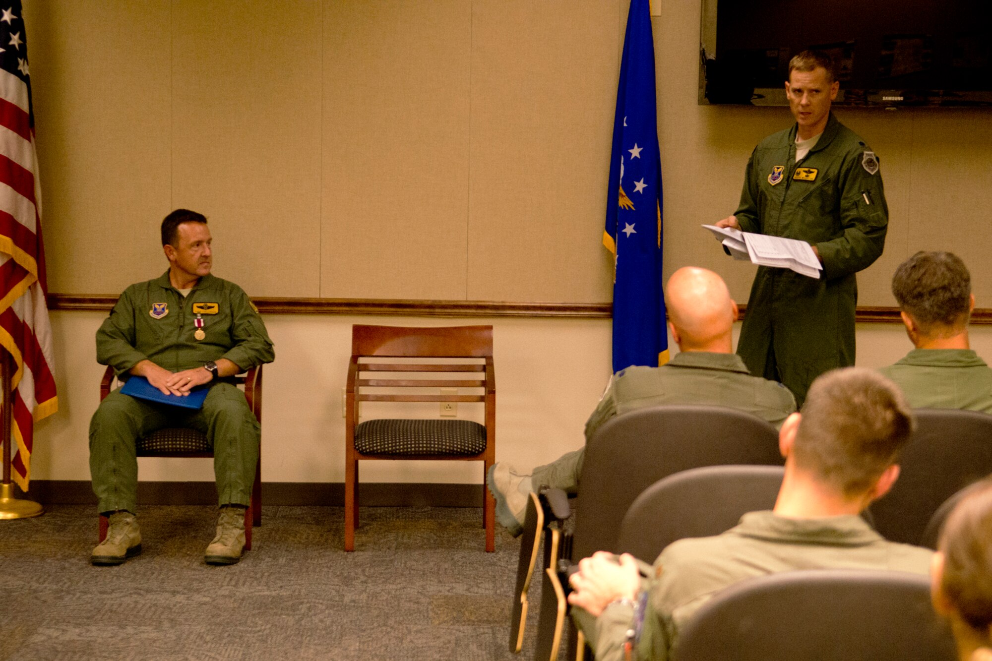 U.S. Air Force Lt. Col. William Wharton (standing), 11th Bomb Squadron commander, is the presiding official during a retirement ceremony for Lt. Col. Todd Callahan, Aug. 9, 2012, Barksdale Air Force Base, La. Callahan (seated) is retiring from the Air Force after serving 27 years in the military. (U.S. Air Force photo by Master Sgt. Greg Steele/Released)